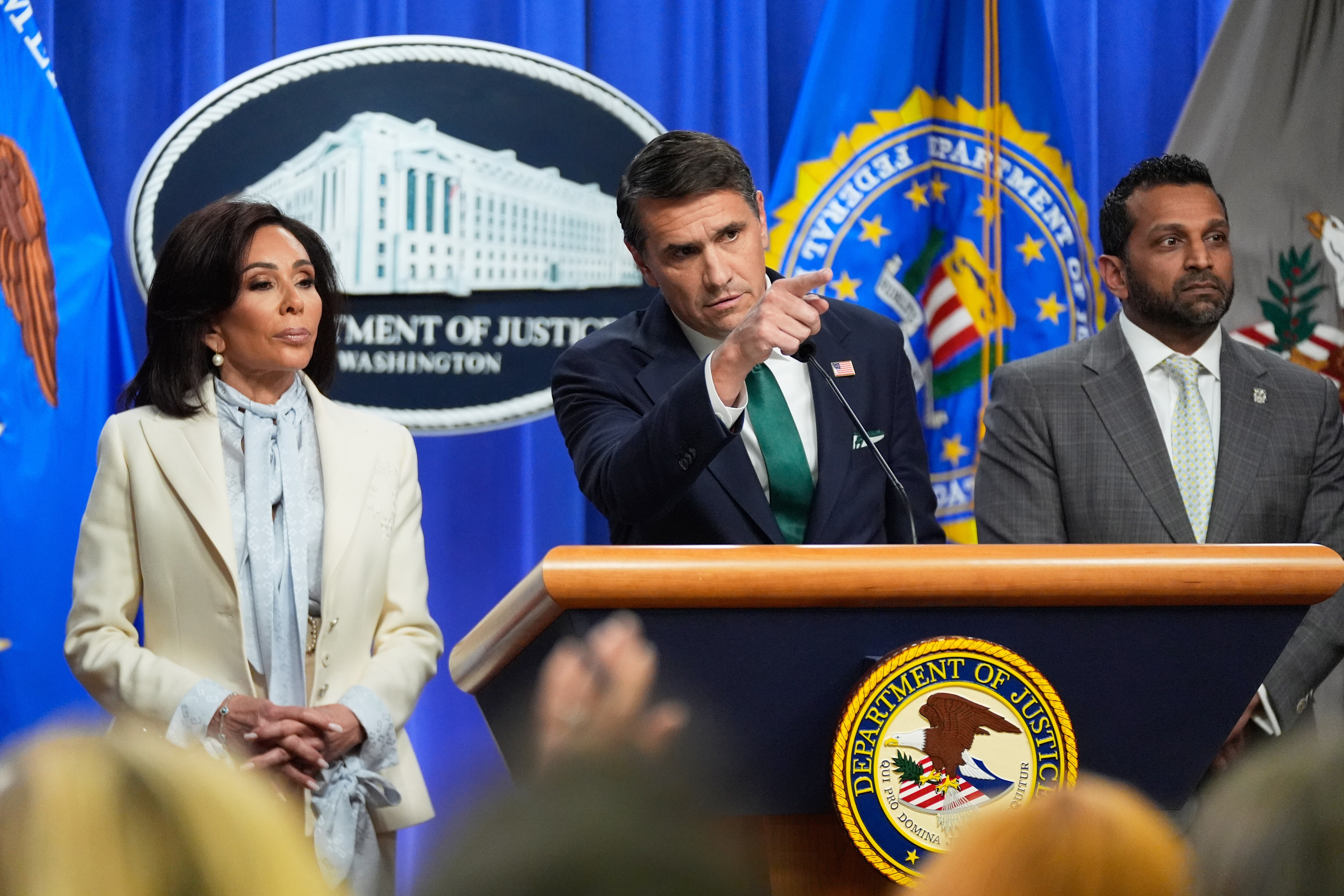 Acting Attorney General Todd Blanche, with U.S. Attorney Jeanine Pirro, left, and FBI Director Kash Patel, right, speaks during a news conference at the Department of Justice on Monday.