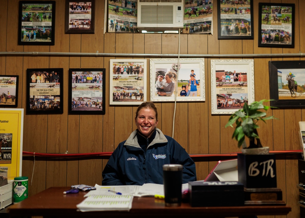 Horse trainer Brittany Russell sits at her desk in her office at Laurel Park racetrack.