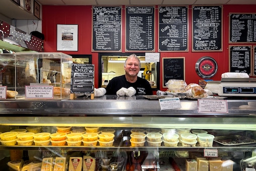 Daryl Robison greets customers from behind the counter at Pastore’s Italian Delly. Customers love the enormous sandwiches, but also come in for the large selection of imported and prepared foods.
