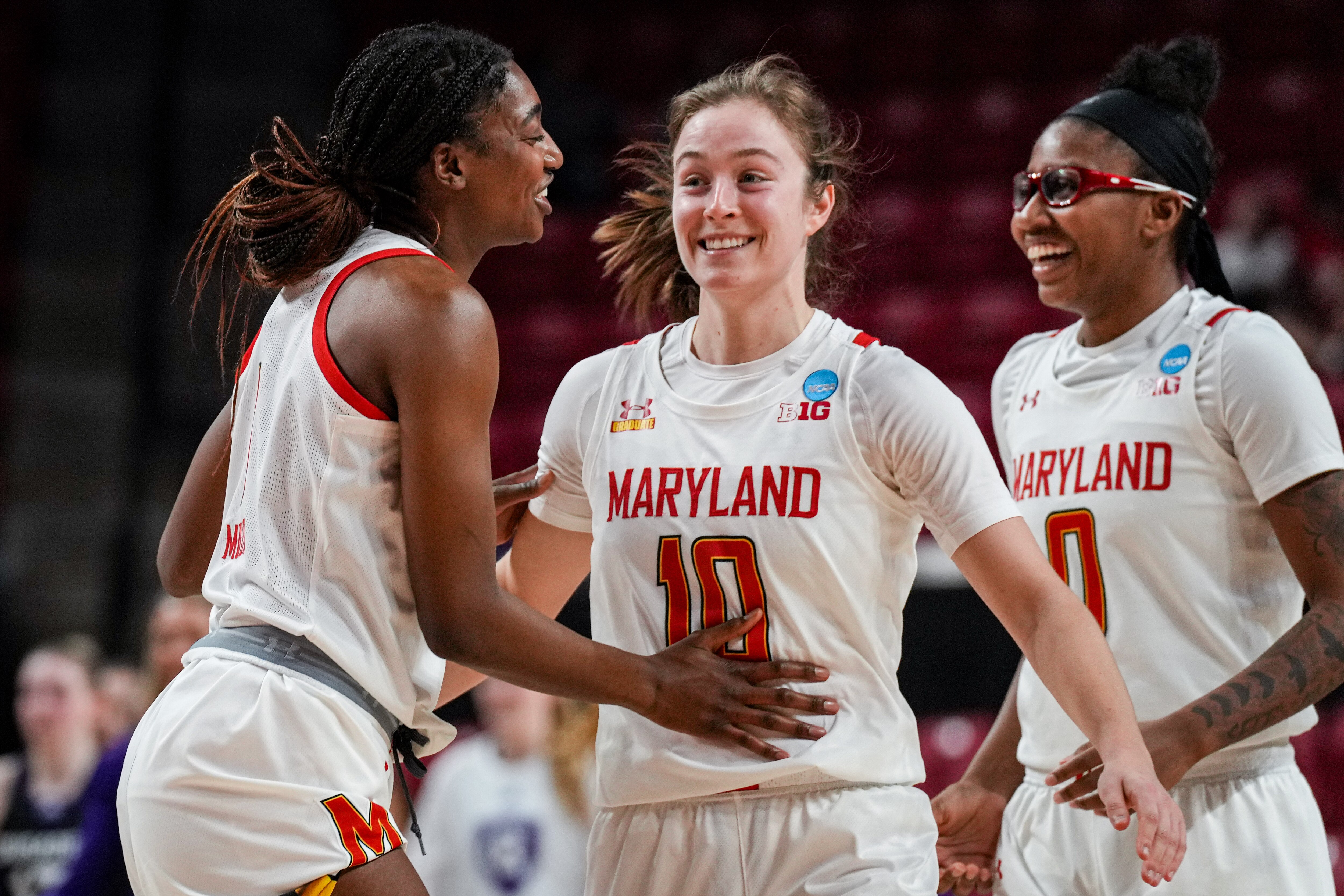 Diamond Miller (1), Abby Meyers (10) and Shyanne Sellers (0) celebrate together at the XFNITY Center court in College Park during the first round of the NCAA Women’s Basketball Tournament. The Terrapin Women's Basketball team beat The Holy Cross Crusaders on Friday, 93-61.