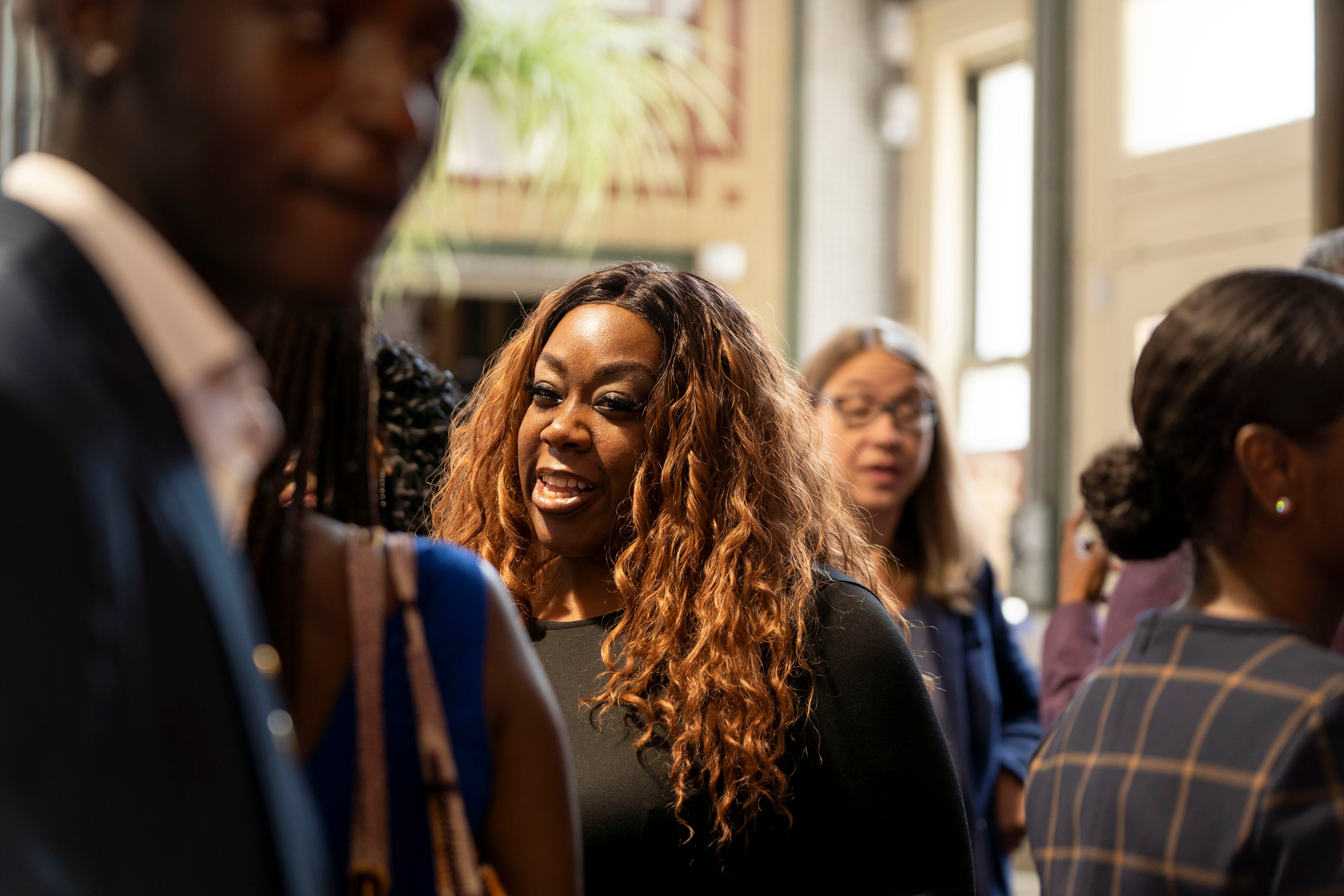 Chief Recovery Officer Shamiah Kerney chats with fund awardees after the presentation.