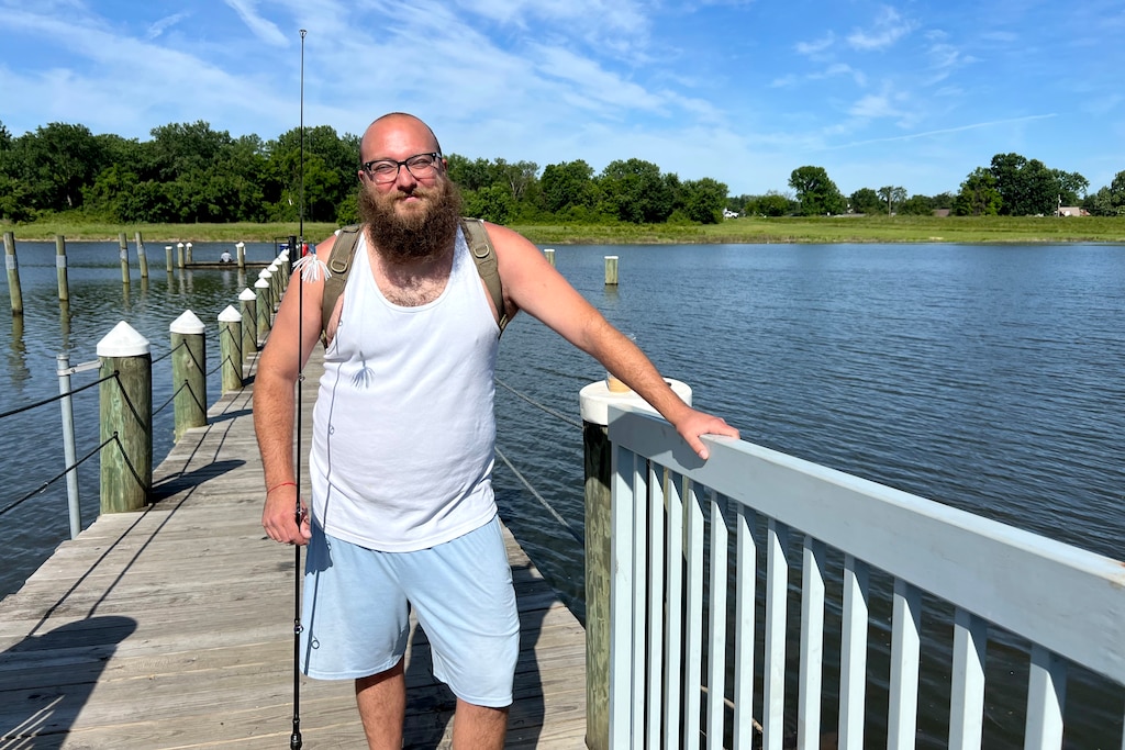 Alexander Prucha fishes at the Anacostia River from the dock at Bladensburg Waterfront Park.