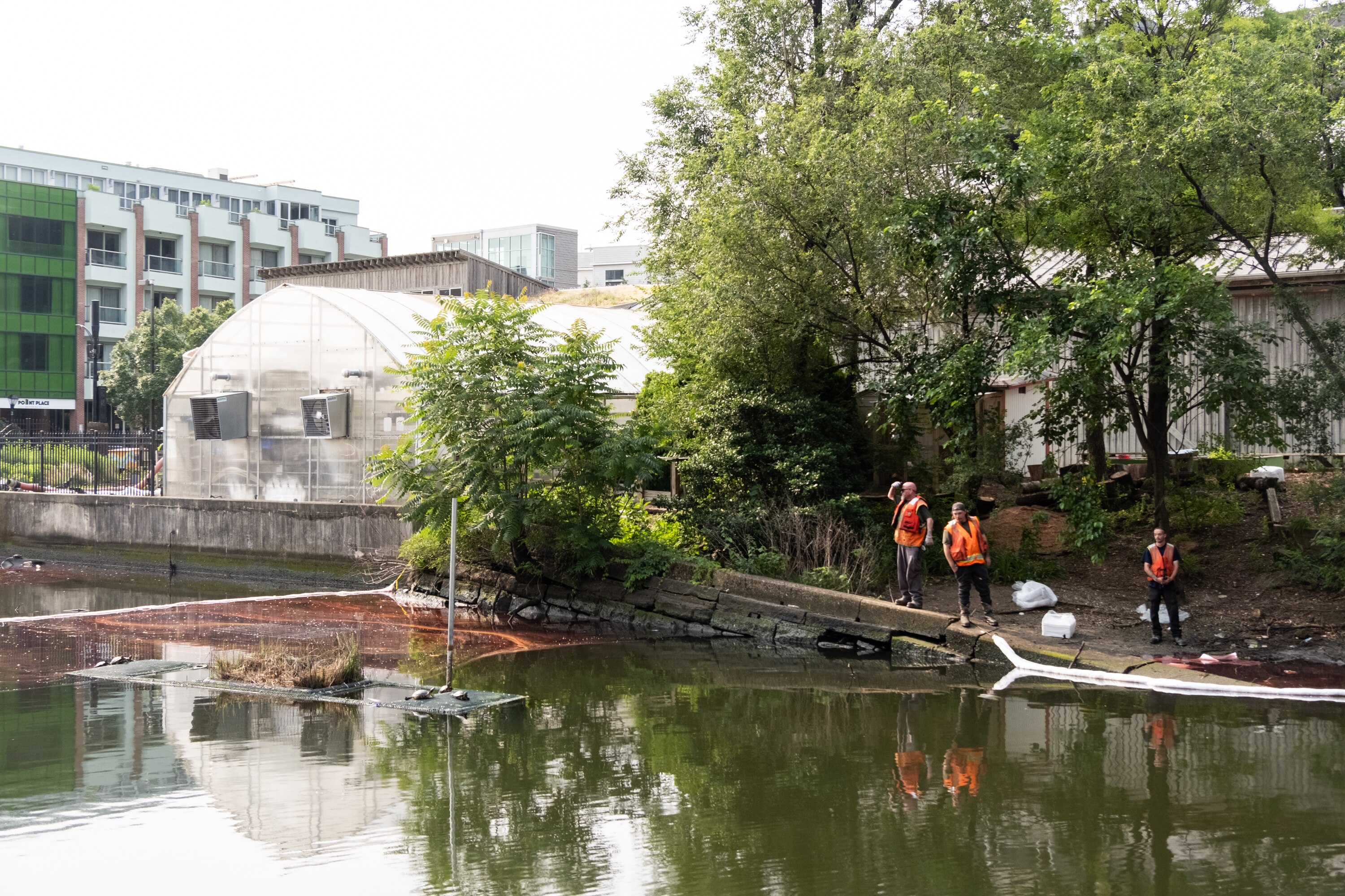 Crews assess an oil spill at an inlet at South Caroline and Lancaster streets Thursday.