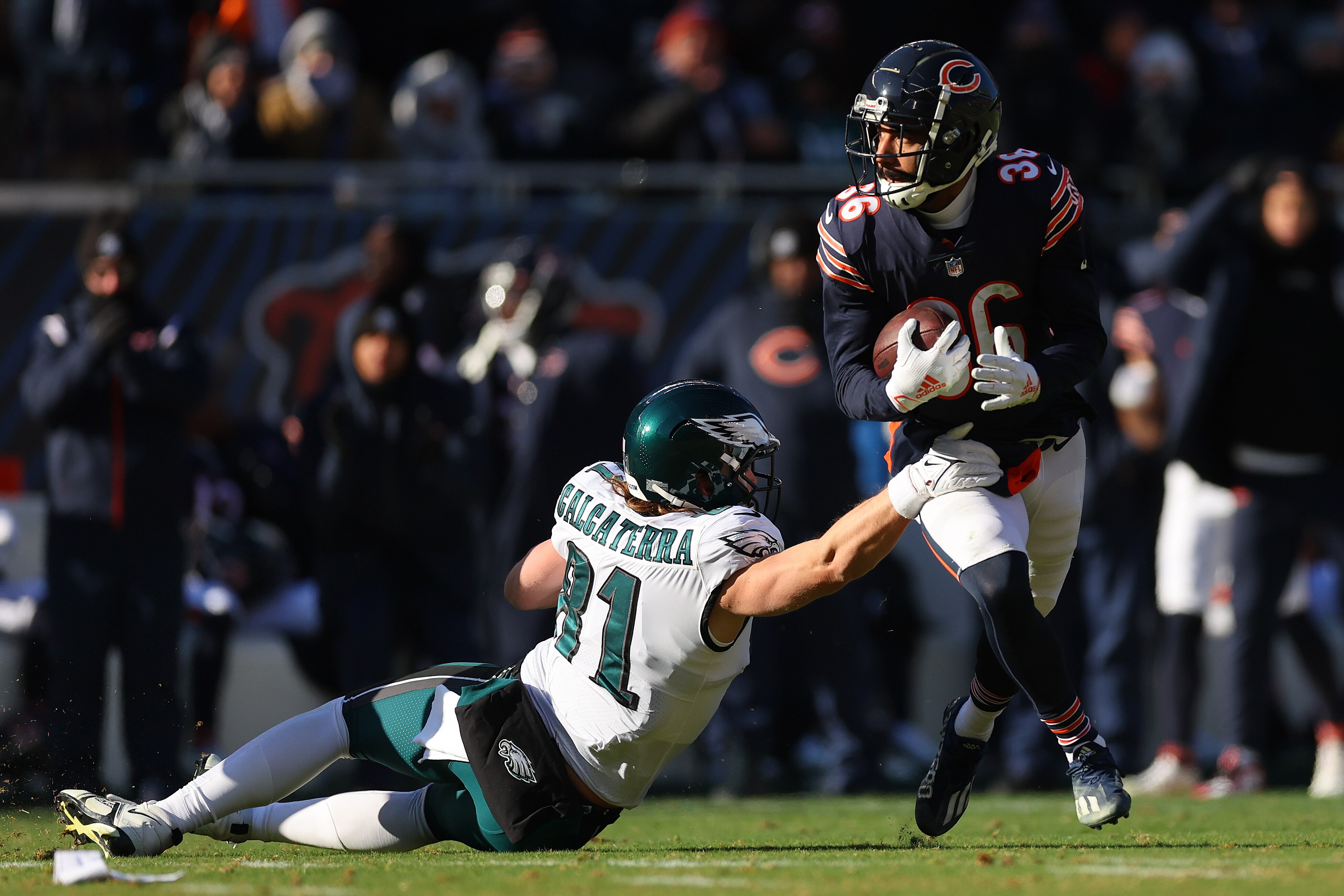 DeAndre Houston-Carson #36 of the Chicago Bears runs the ball after an interception while defended by Grant Calcaterra #81 of the Philadelphia Eagles during the second quarter at Soldier Field on December 18, 2022 in Chicago, Illinois.