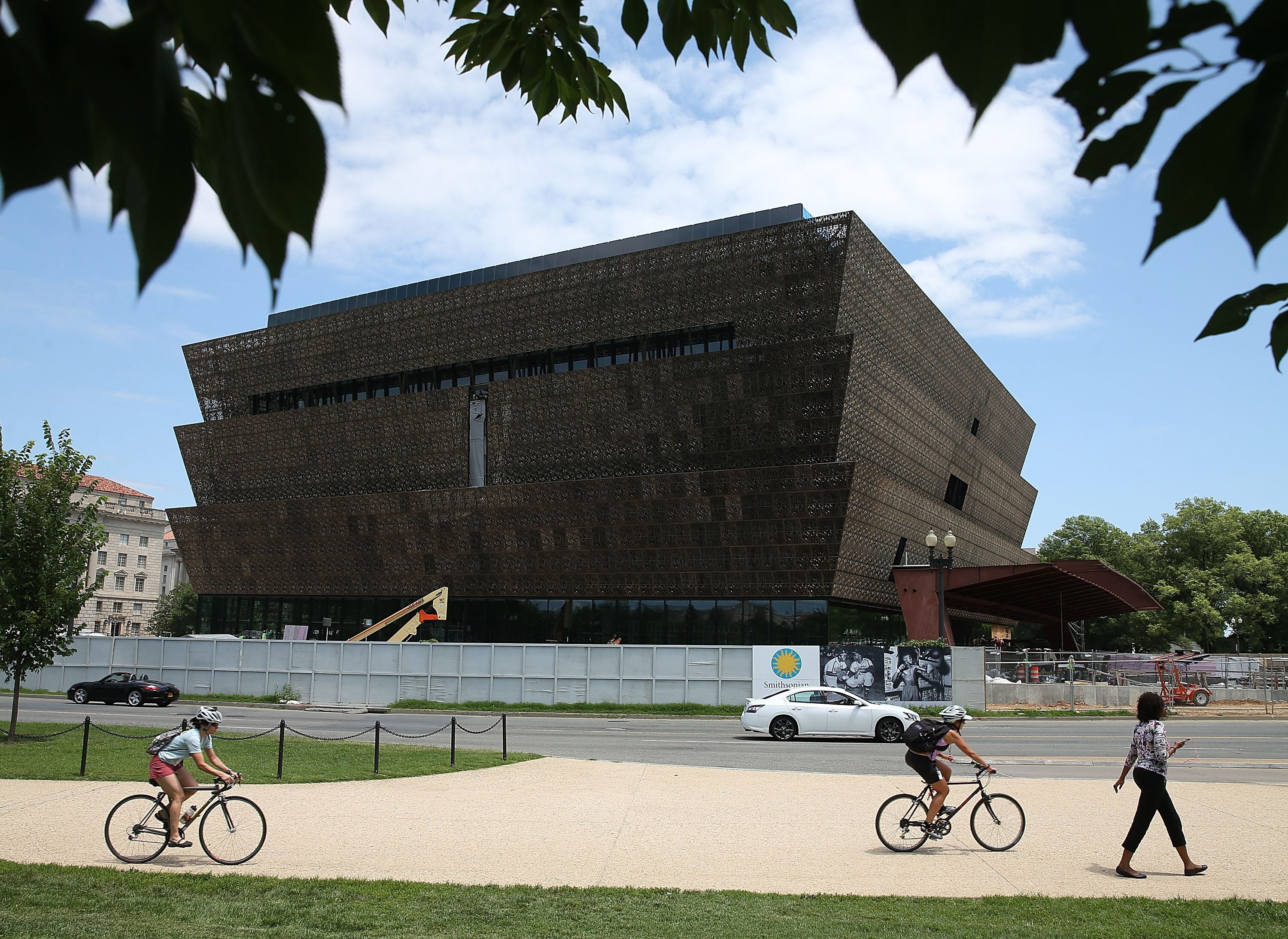 WASHINGTON, DC - JULY 16: Tourist walk past the Smithsonian Museum of African American History and Culture that is currently under construction July 16, 2015 in Washington, DC. The museum is located on the National Mall near the Washington Monument and is scheduled to be completed and dedicated in 2016.Ê (Photo by Mark Wilson/Getty Images)