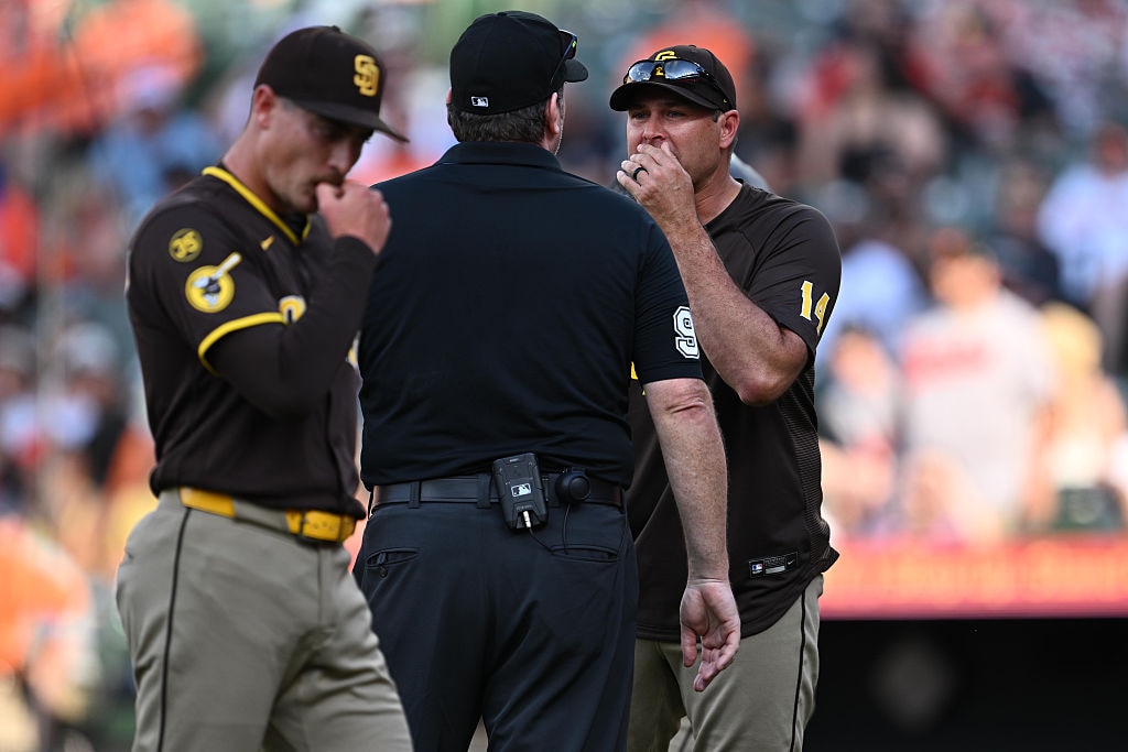 Padres manager Craig Stammen argues with umpire Chris Conroy after pitcher Ron Marinaccio, foreground, is ejected in the ninth inning of Saturday's game.