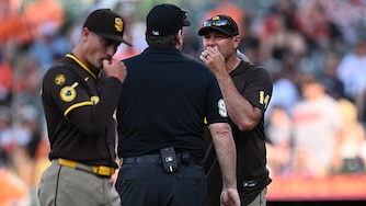 Padres manager Craig Stammen argues with umpire Chris Conroy after pitcher Ron Marinaccio, foreground, is ejected in the ninth inning of Saturday's game.