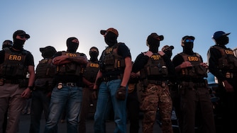 NEWARK, NEW JERSEY - MAY 28: ICE agents stand guard outside of the federal immigration center at Delaney Hall, where ICE is housing detained immigrants, on May 28, 2026 in Newark, New Jersey. The ongoing protests, which became tense over the holiday weekend, come amid reports of a hunger strike by detainees.