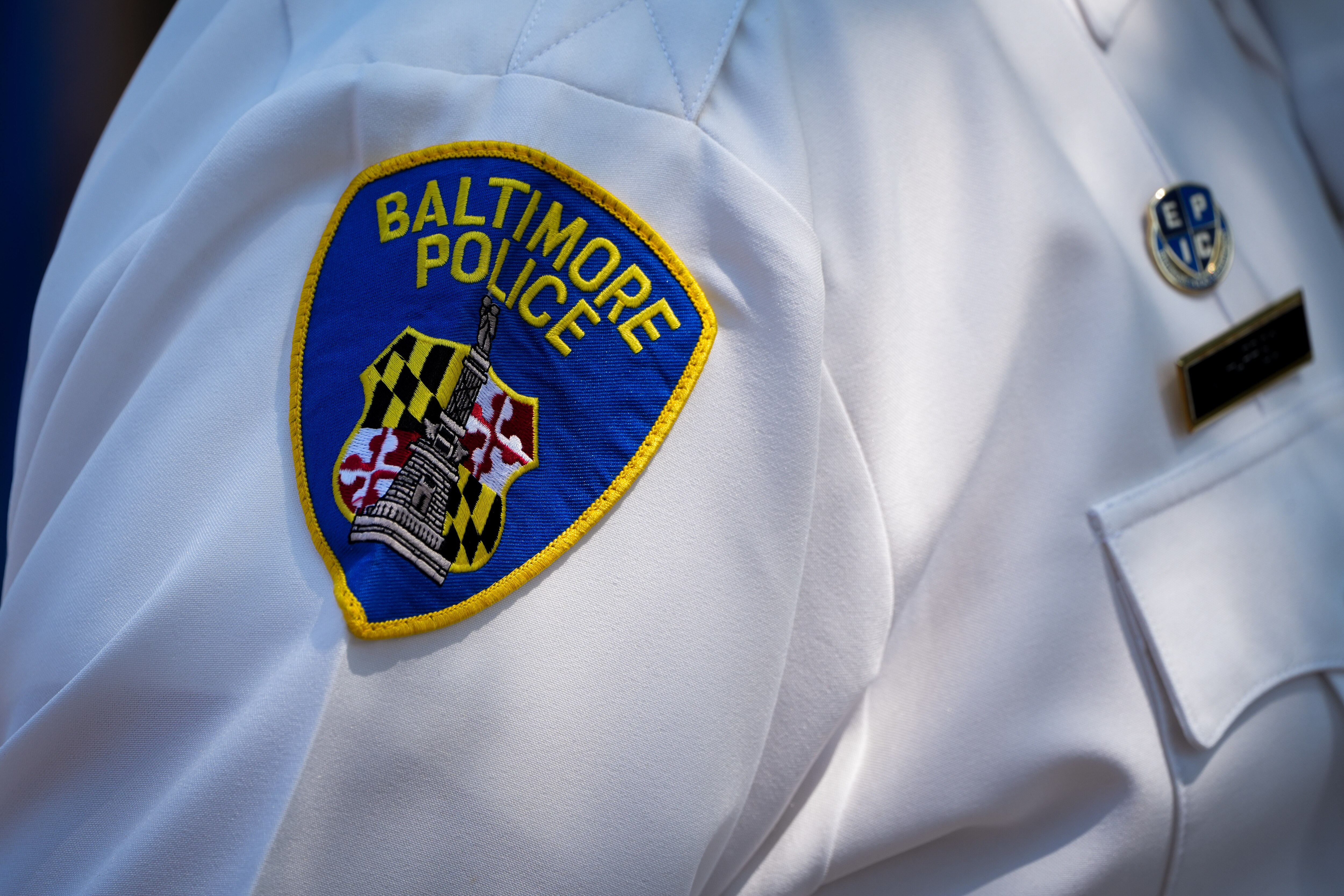 A patch on the uniform of Baltimore Police Commissioner Michael Harrison as he speaks at a press conference outside Tench Tilghman Elementary/Middle School on 8/24/22.