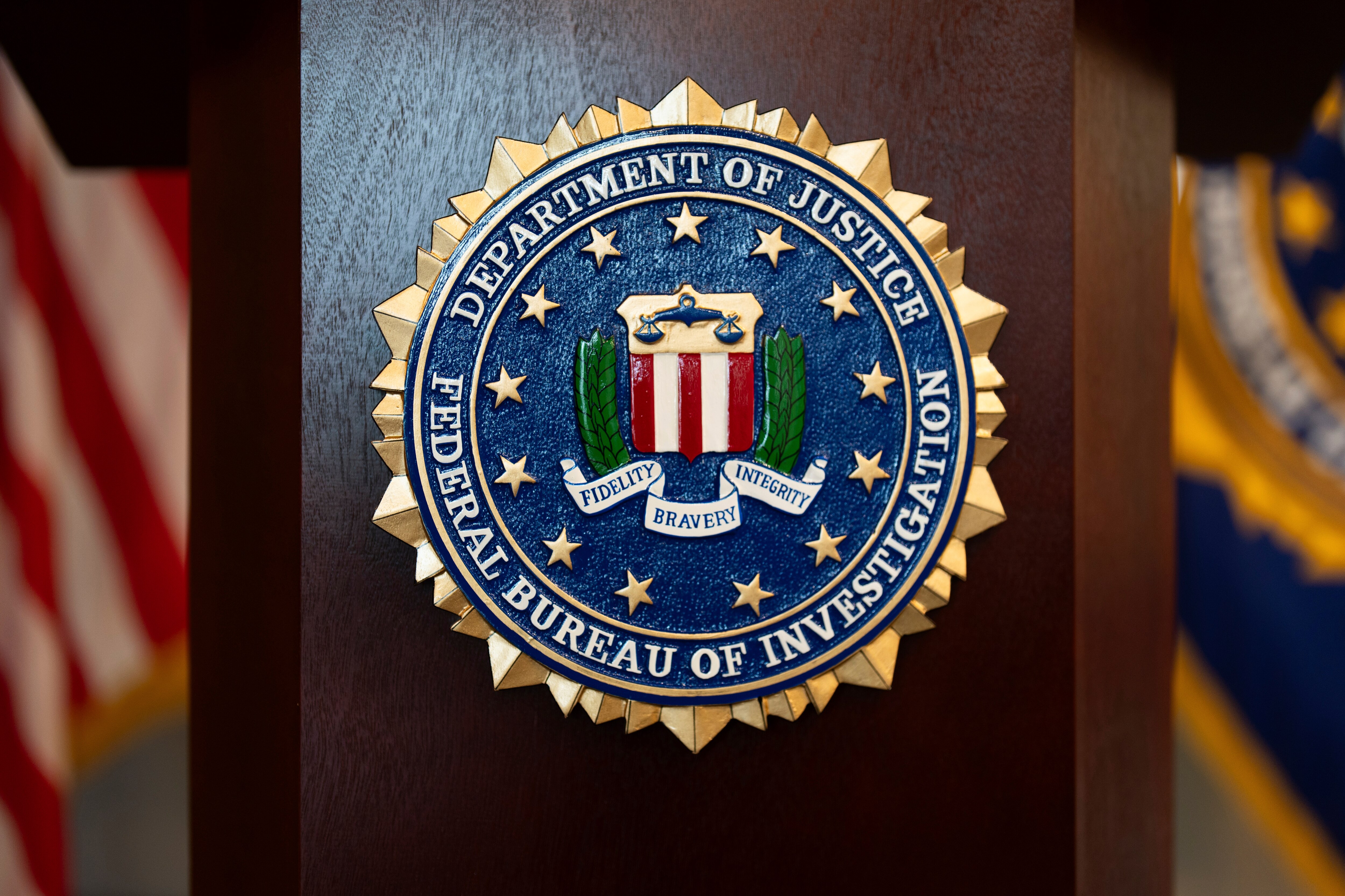 FILE - An FBI seal is displayed on a podium before a news conference at the field office in Portland, Ore., Jan. 16, 2025.