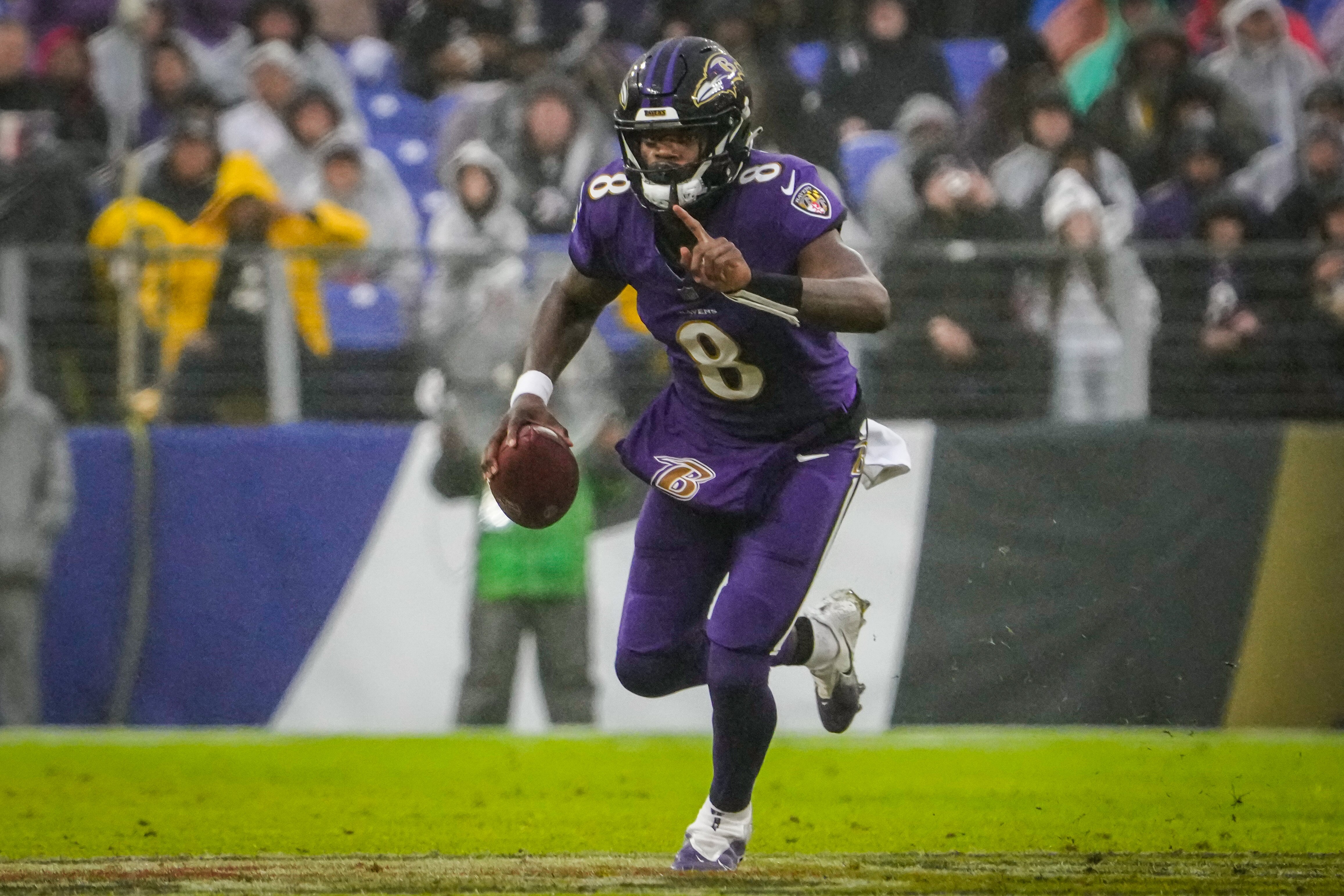 Baltimore Ravens quarterback Lamar Jackson (8) runs down the field during the third quarter against the Los Angeles Rams at M&T Bank Stadium on Sunday, Dec. 10, 2023.