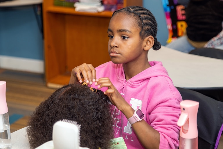 Participants of "The Coiloquium" learning basic curly haircare skills and creating hair stories to be featured in "The Coilection", an anthology.