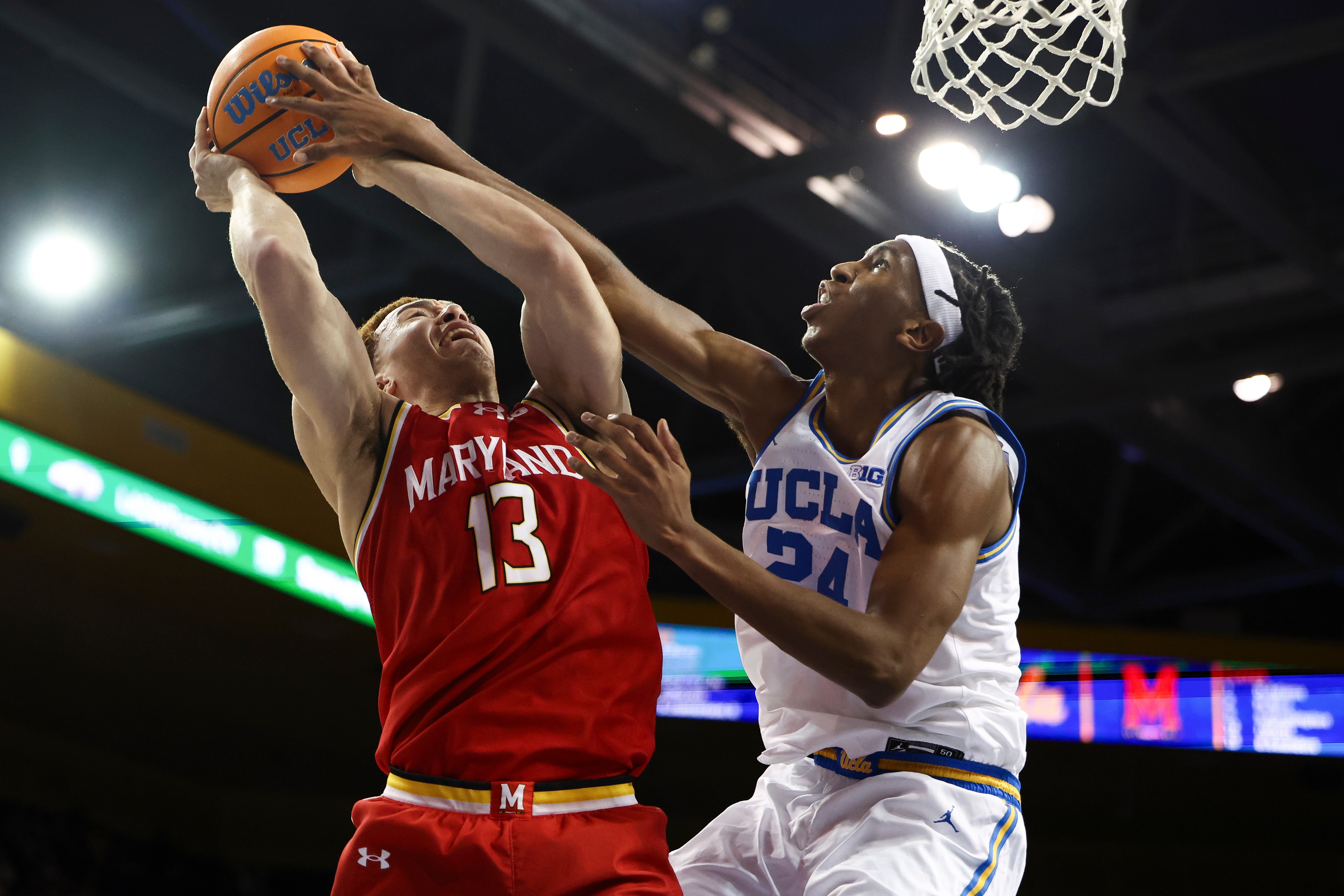 Maryland forward Elijah Saunders draws a foul against UCLA center Steven Jamerson II during the first half of the Bruins’ 67-55 win Saturday.