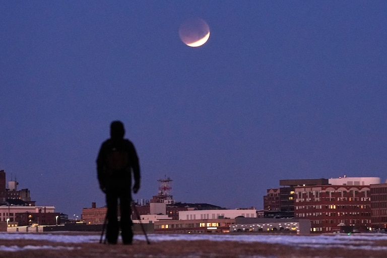 A man views the lunar eclipse, Tuesday, March 3, 2026, in South Portland, Maine.