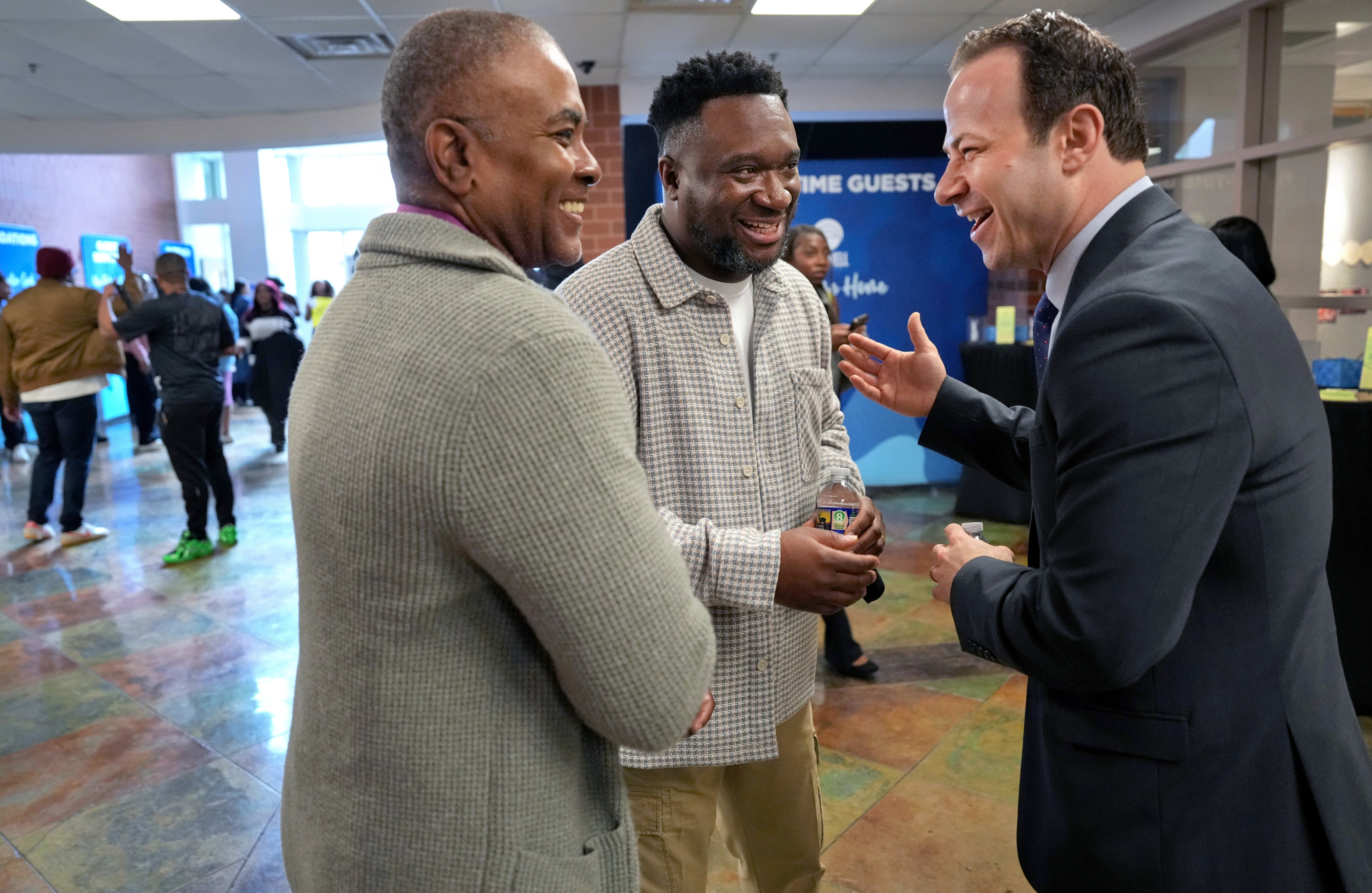 Andrew Friedson, right, chats with Pastor Victor Ehiemere, center, and Jerome Leonard after Friedson attended an early Sunday service at The Well Church in Rockville.