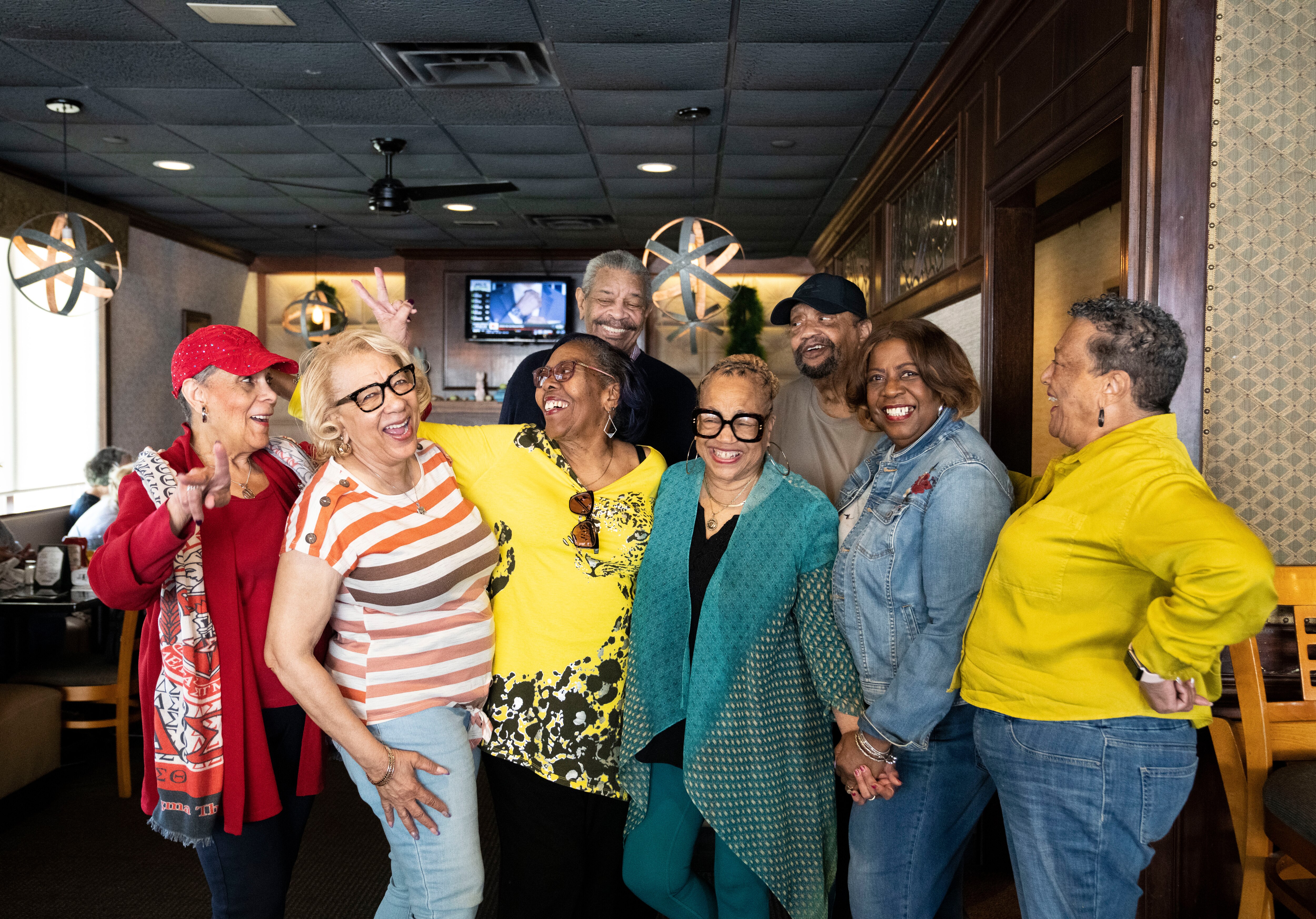 Back row, left, Emory Bernard Woods and right, Paul King. Front row from left, Patricia Waddy,  Marsha “Bubbles” Logan, Cynthia Lambirth, Fredricka Williams, Joyce L. Gillard, and Denise Chappell pose for a portrait at Kelsey's Restaurant Irish Pub in Ellicott City, Wednesday, April 23, 2025.