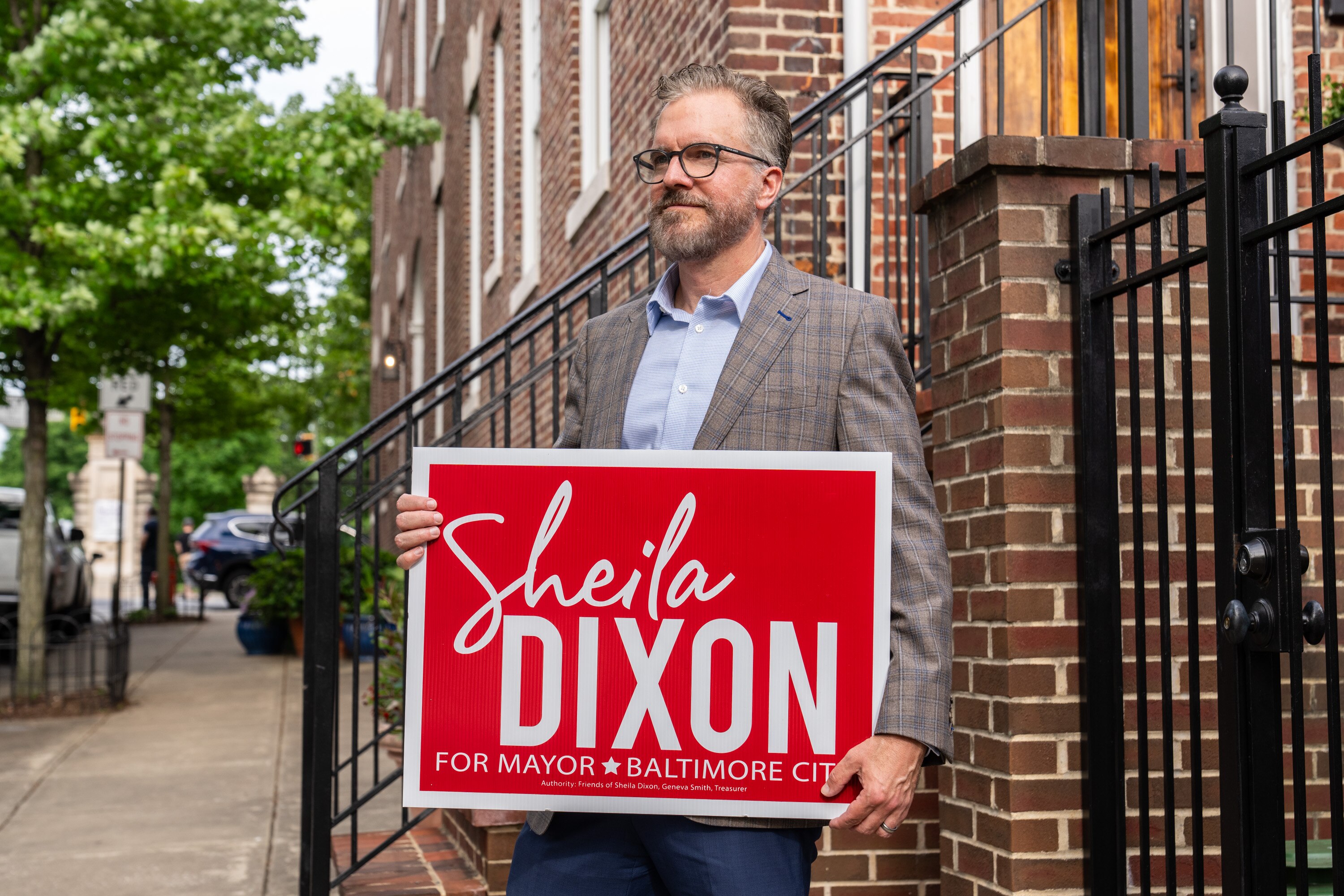Arch McKown poses for a portrait outside his house with his Sheila Dixon yard sign.