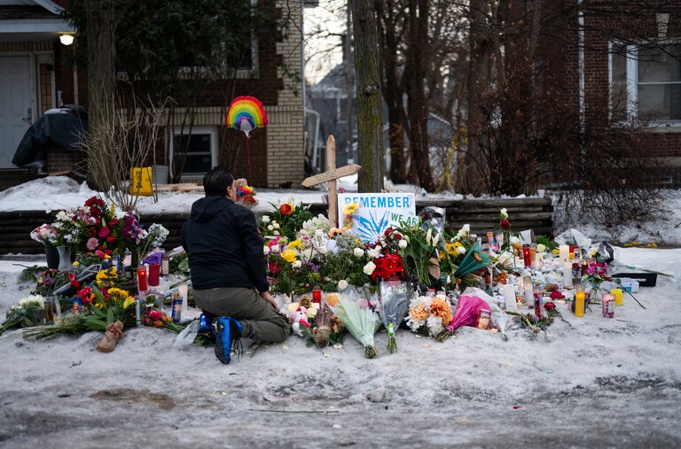 MINNEAPOLIS, MINNESOTA - JANUARY 08: A man kneels at a memorial for Renee Nicole Good near the site of her shooting on January 08, 2026 in Minneapolis, Minnesota. According to federal officials, an ICE agent shot and killed Good during a confrontation yesterday in south Minneapolis.