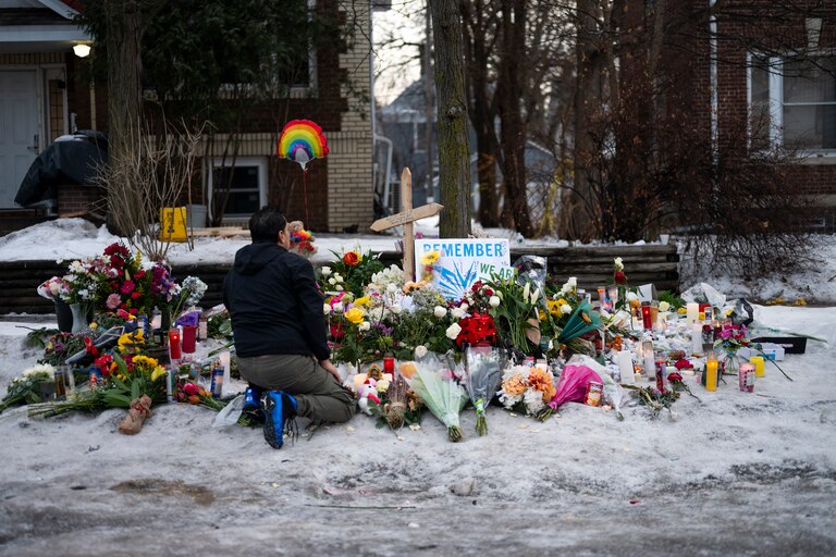 MINNEAPOLIS, MINNESOTA - JANUARY 08: A man kneels at a memorial for Renee Nicole Good near the site of her shooting on January 08, 2026 in Minneapolis, Minnesota. According to federal officials, an ICE agent shot and killed Good during a confrontation yesterday in south Minneapolis.