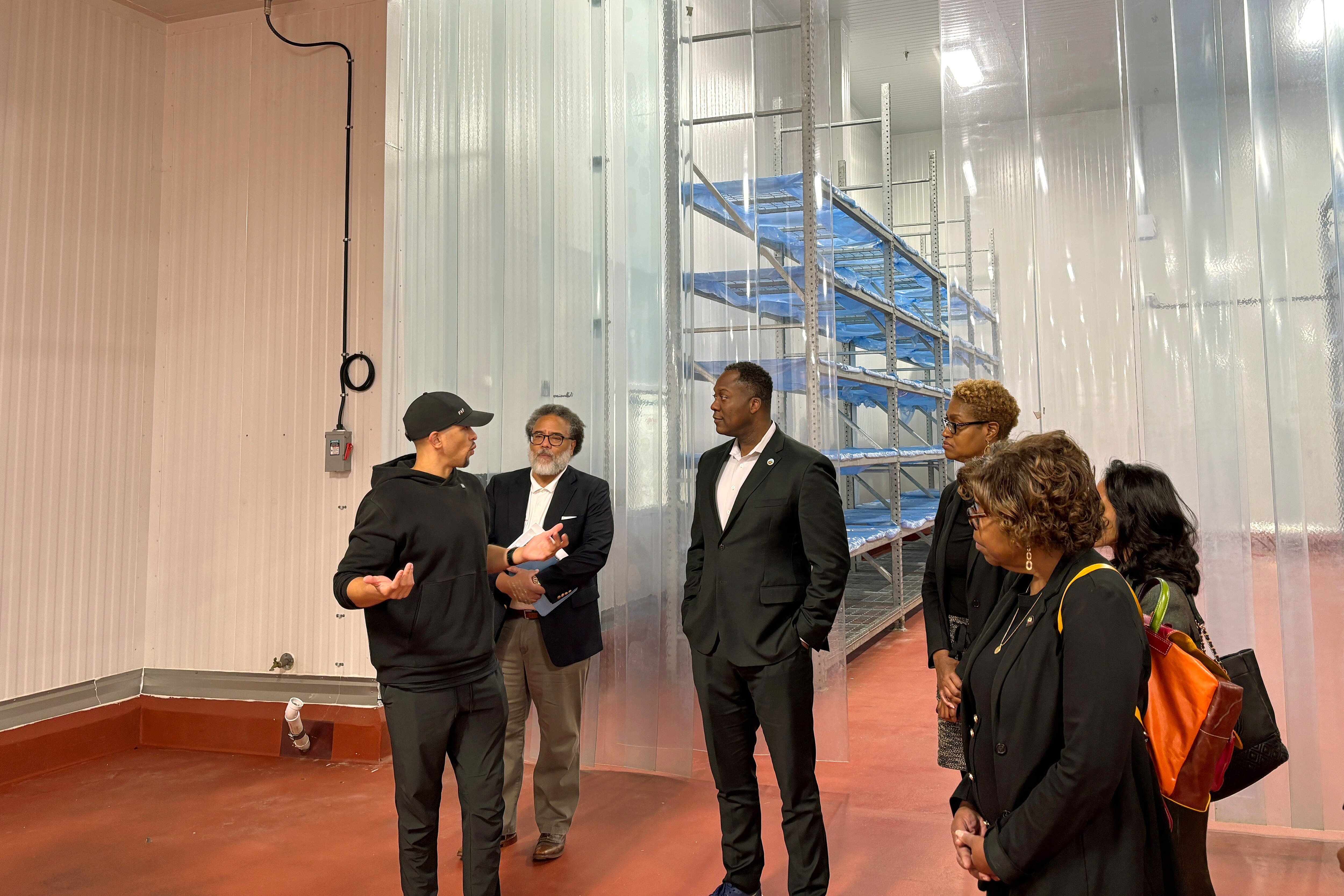 Feast & Fettle CEO Carlos Ventura (left) tours his company's new Elkridge facility with the state's commerce secretary Harry Coker Jr. (center) and Howard County Executive Calvin Ball (right) on Nov. 12, 2025.