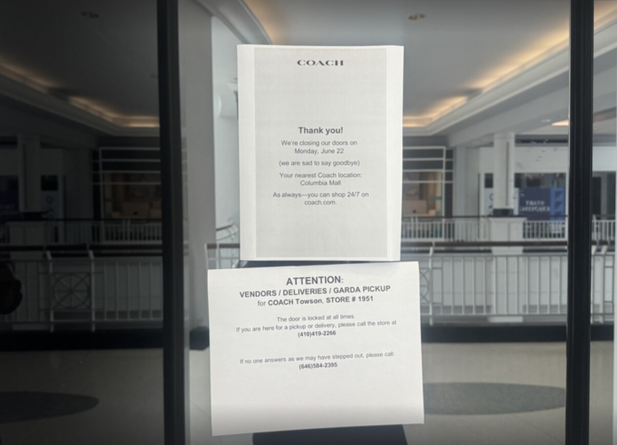 A sign hangs on the glass doors of the Coach store at Towson Town Center informing customers the location closed on Monday, June 22, 2026.