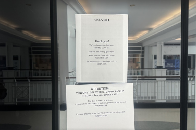 A sign hangs on the glass doors of the Coach store at Towson Town Center informing customers the location closed on Monday, June 22, 2026.