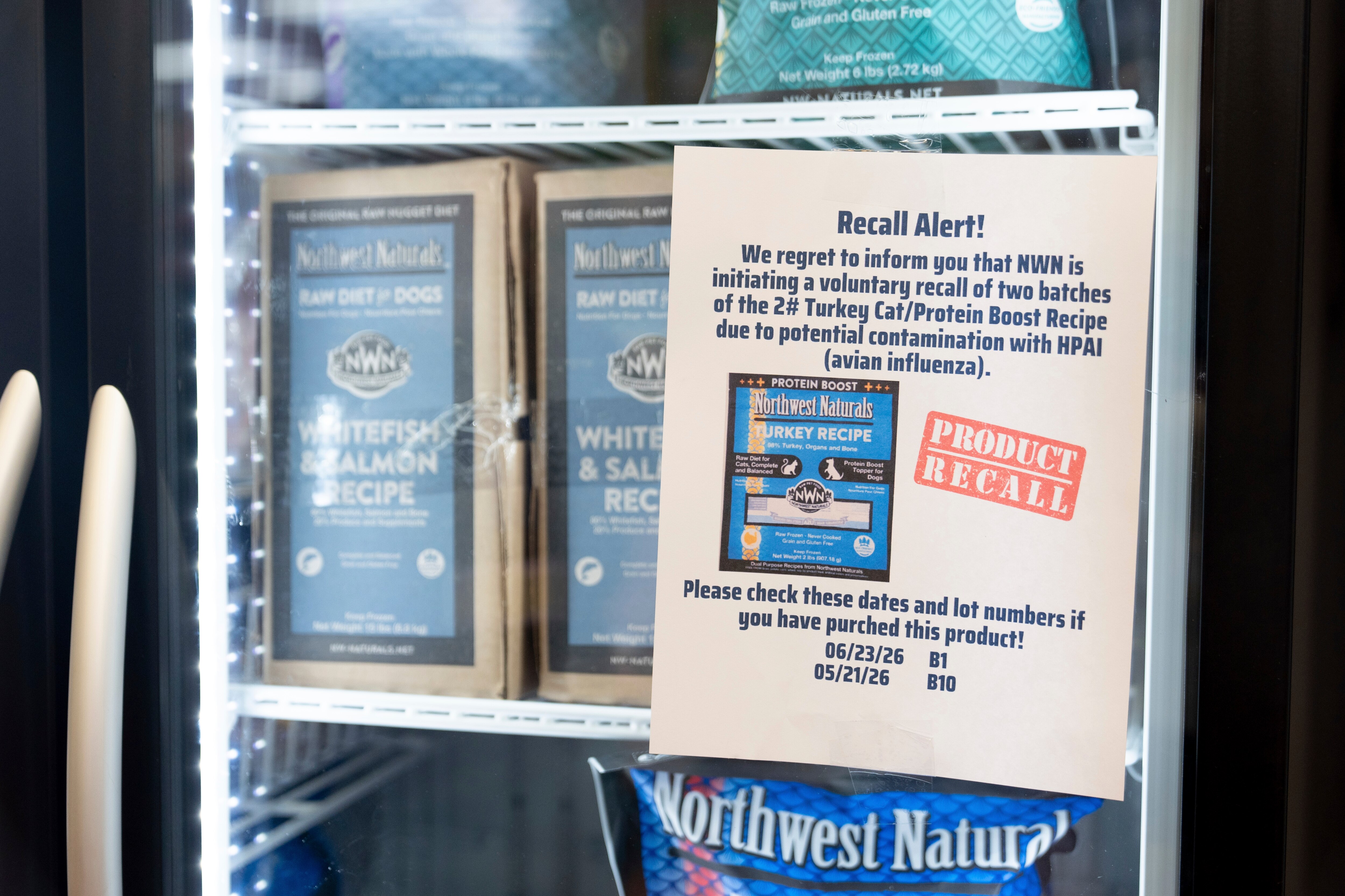 A recall alert is displayed on a refrigerator at a pet store after Northwest Naturals issued a voluntary recall on two batches of their 2-pound feline turkey recipe raw frozen pet food on in Tigard, Oregon.