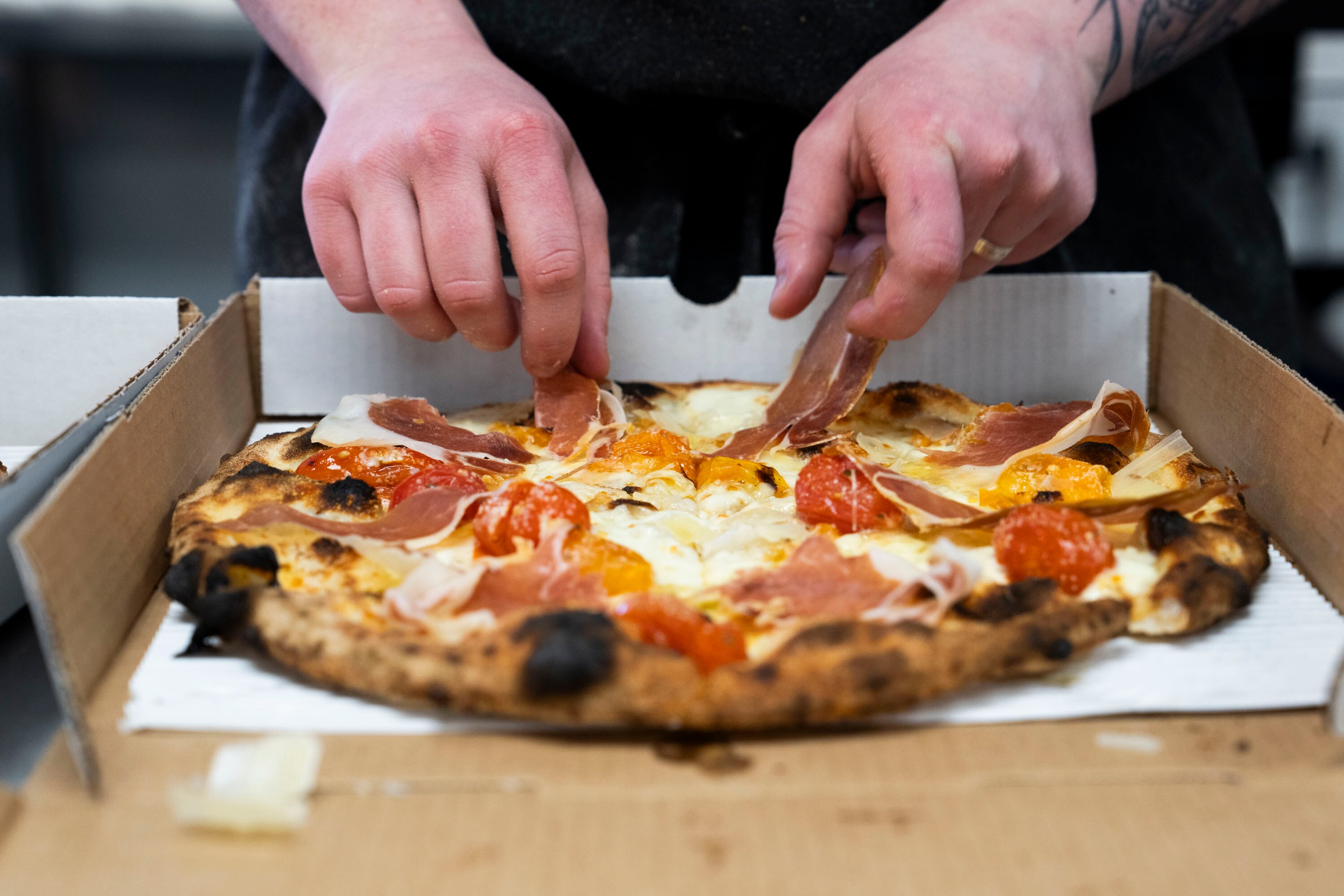 Rachel Crout makes a neo-Neapolitan pizza at ZaVino’s.