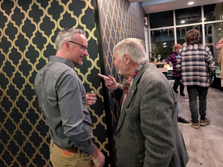 Aldermen Rob Savidge, left, and Ross Arnet chat during an election night watch party in Annapolis. Savidge was re-elected without opposition, while Arnet is retiring.