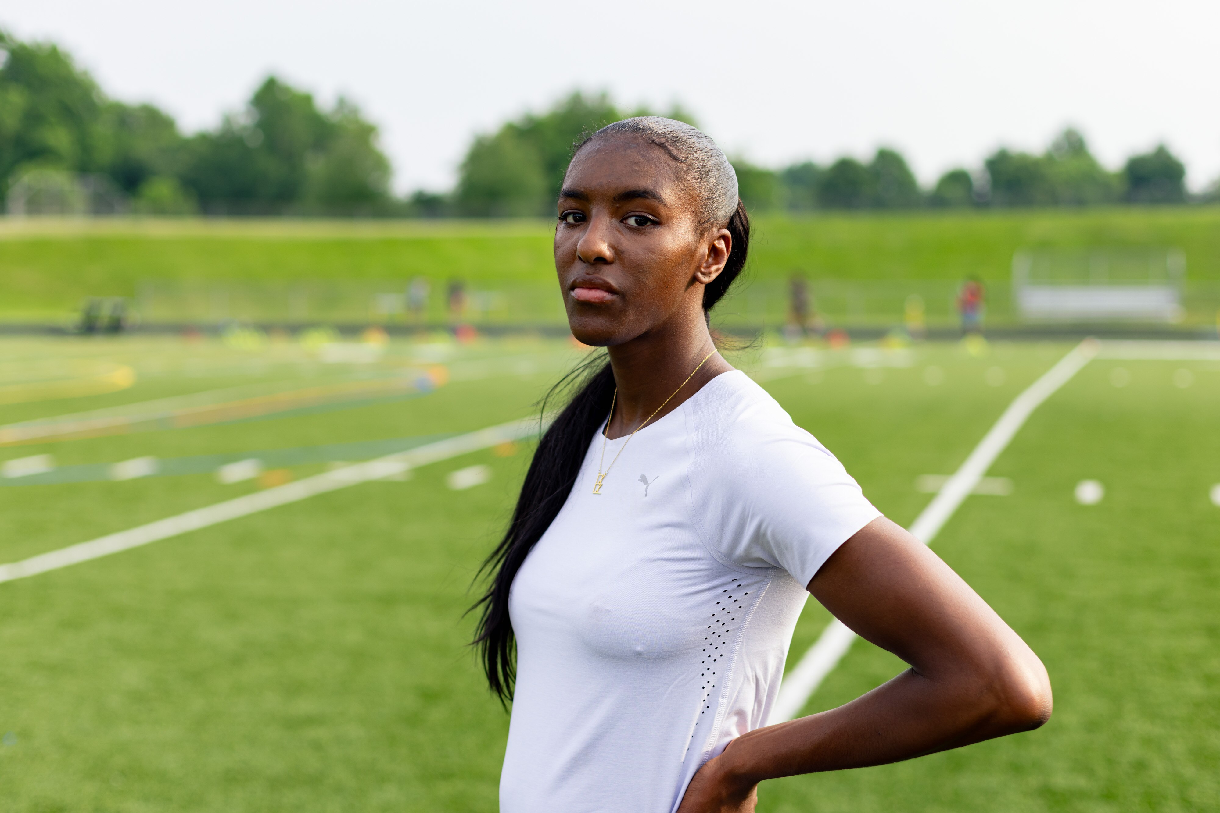 New Town sprinter Elise Cooper stands before practice with the Owings Mills Track Club at New Town High School in Owings Mills, MD on Thursday, June 5, 2025.