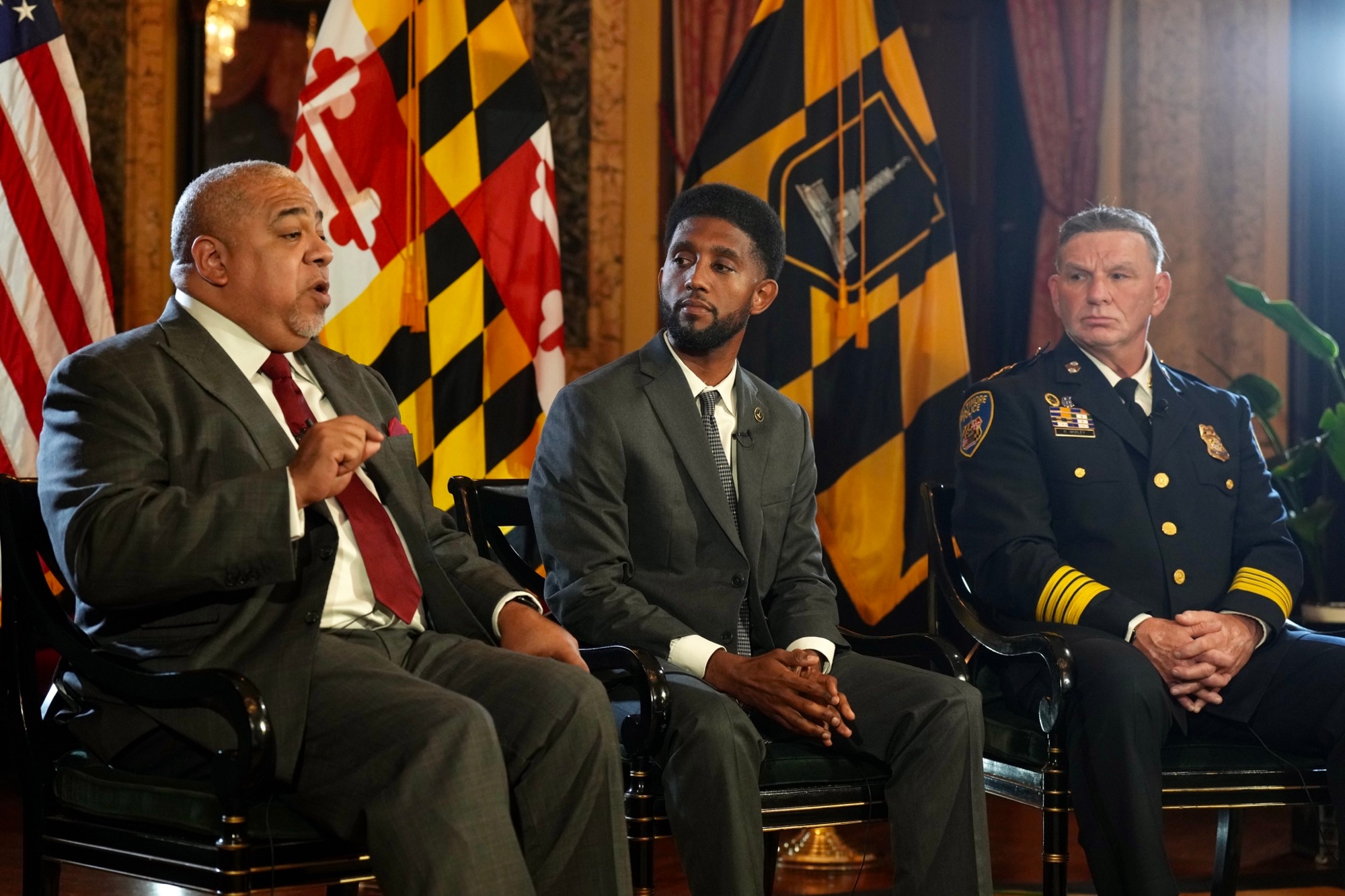 From left, former Police Commissioner Michael Harrison, Mayor Brandon Scott and Acting Commissioner Richard Worley sit down for an interview with The Baltimore Banner and its media partner, WJZ-TV at City Hall on July 12, 2023. (Kaitlin Newman/The Baltimore Banner)