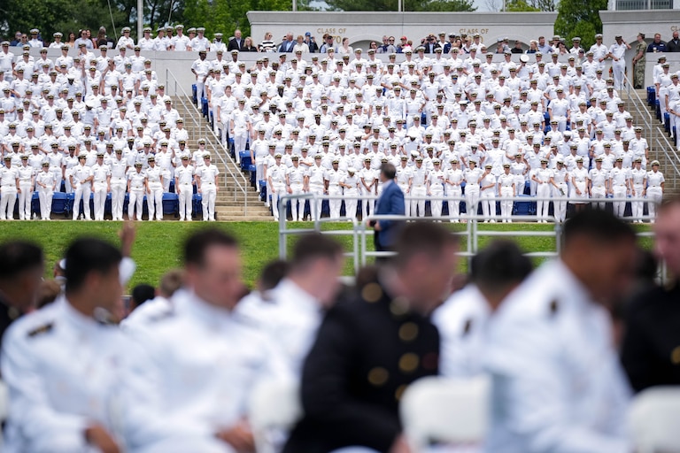 Midshipmen not yet graduating stand to recognize the U.S. Naval Academy Class of 2025 during their graduation ceremony at the Navy-Marine Corps Memorial Stadium in Annapolis, Md. on Friday, May 23, 2025.