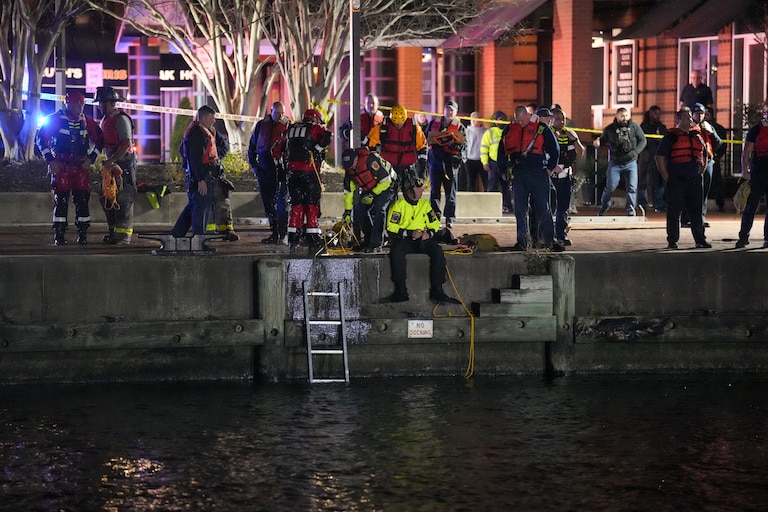 More than a dozen Baltimore fire trucks and police cars lined the area near the Pier 5 Pavilion on Tuesday, Nov. 18, 2025, as divers entered the water and rescue boats searched for the water.
