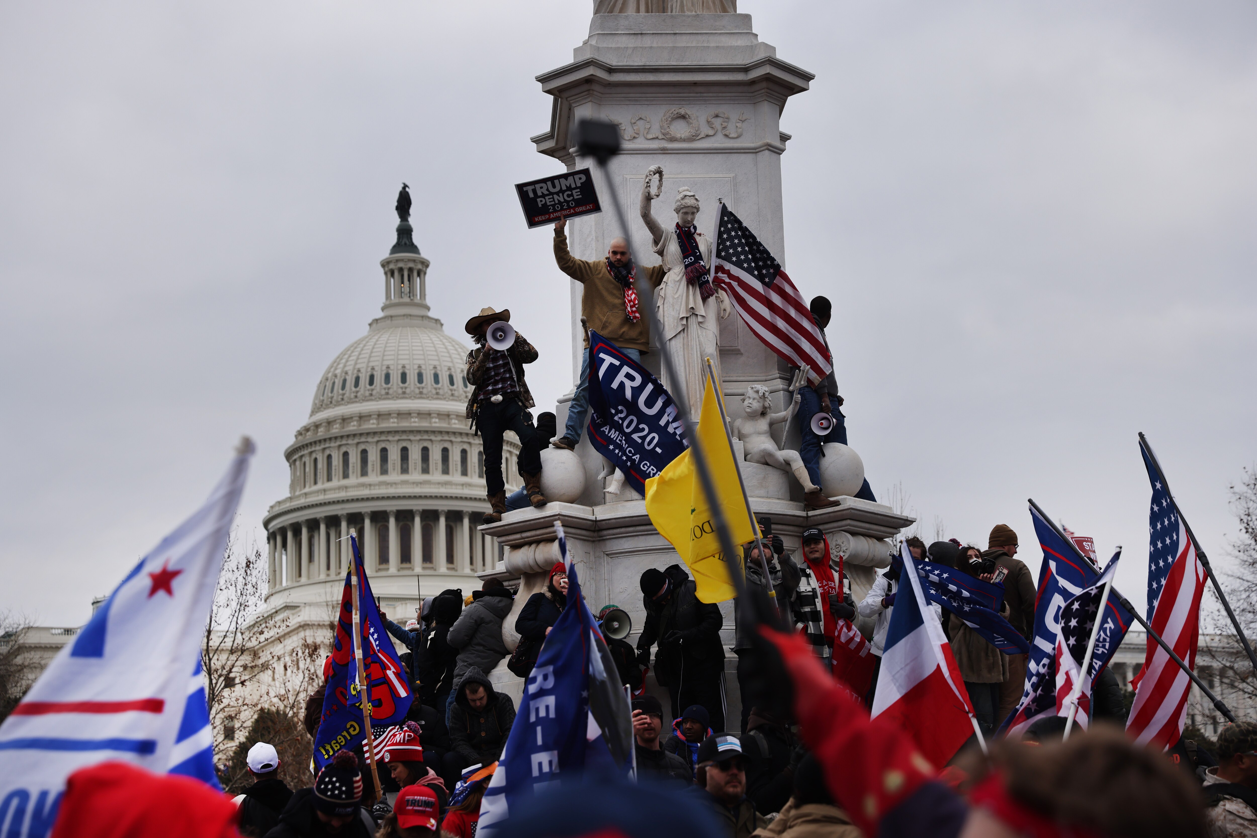 WASHINGTON, DC - JANUARY 06: Trump supporters gather outside the U.S. Capitol building following a "Stop the Steal" rally on January 06, 2021 in Washington, DC. A pro-Trump mob stormed the Capitol earlier, breaking windows and clashing with police officers. Trump supporters gathered in the nation's capital to protest the ratification of President-elect Joe Biden's Electoral College victory over President Donald Trump in the 2020 election.