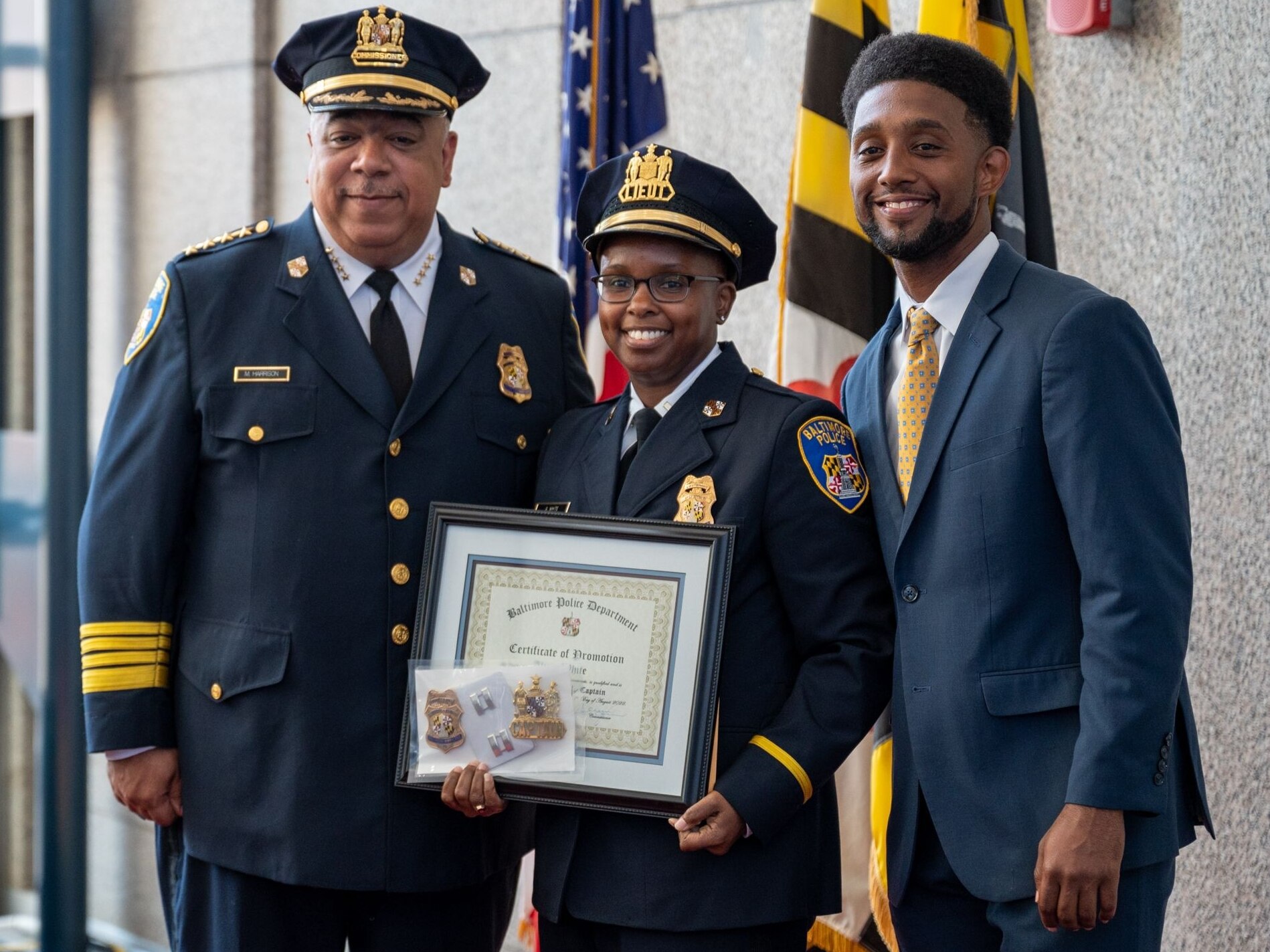 Baltimore Police Commissioner Michael Harrison, left, and Mayor Brandon Scott, right, at the promotion to captain for Alicia White, whose name became known around the country after the death of Freddie Gray.