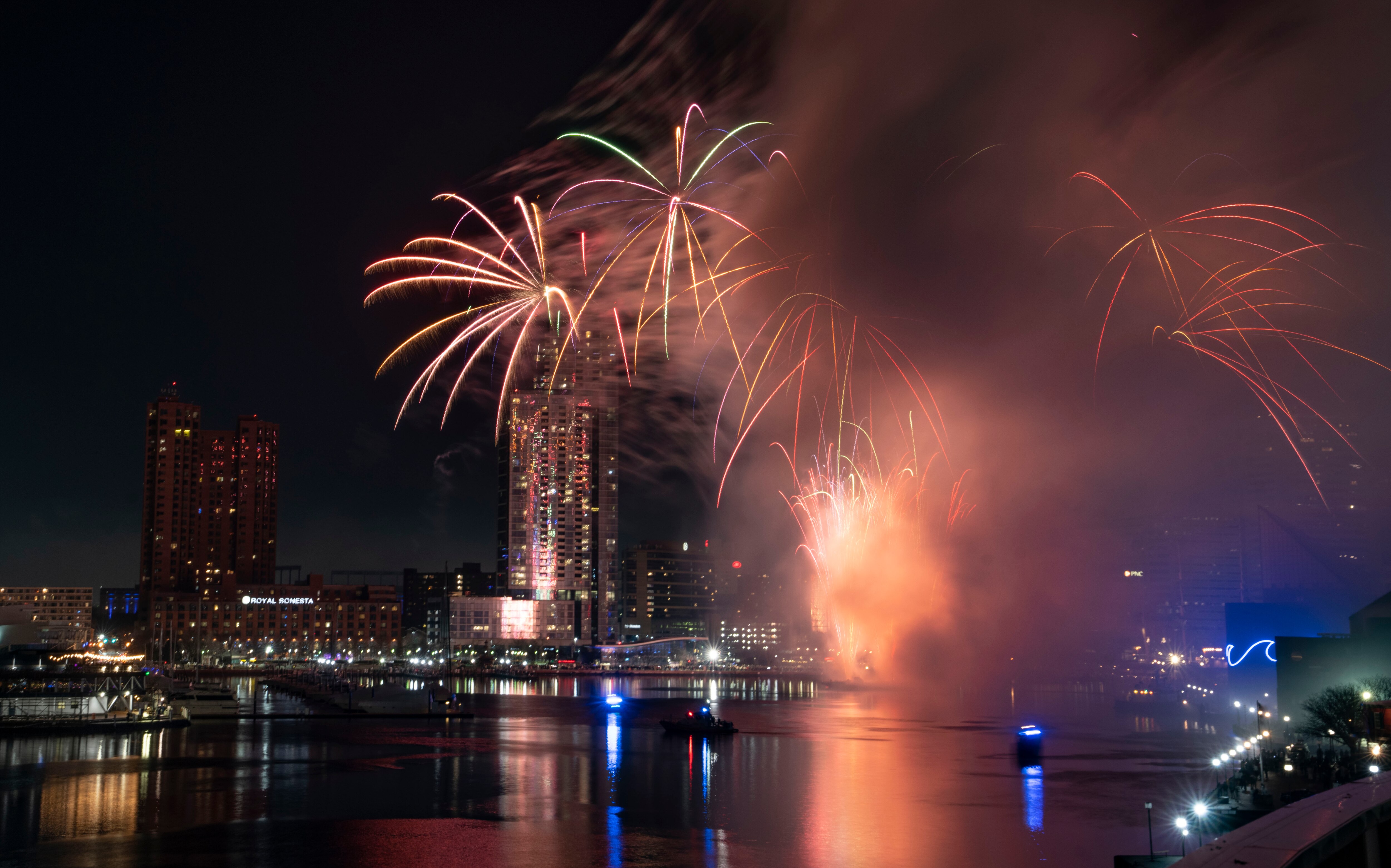 Fireworks shoot off into the sky to celebrate the New Year, seen from the fourth-floor terrace of the Four Seasons Hotel Baltimore, Sunday, January 1, 2023.
