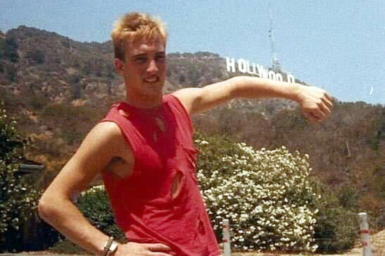 Young Robert Popik with the Hollywood sign in California. He went by "Woody," short for "Hollywood," when working the DJ booth at sports games.