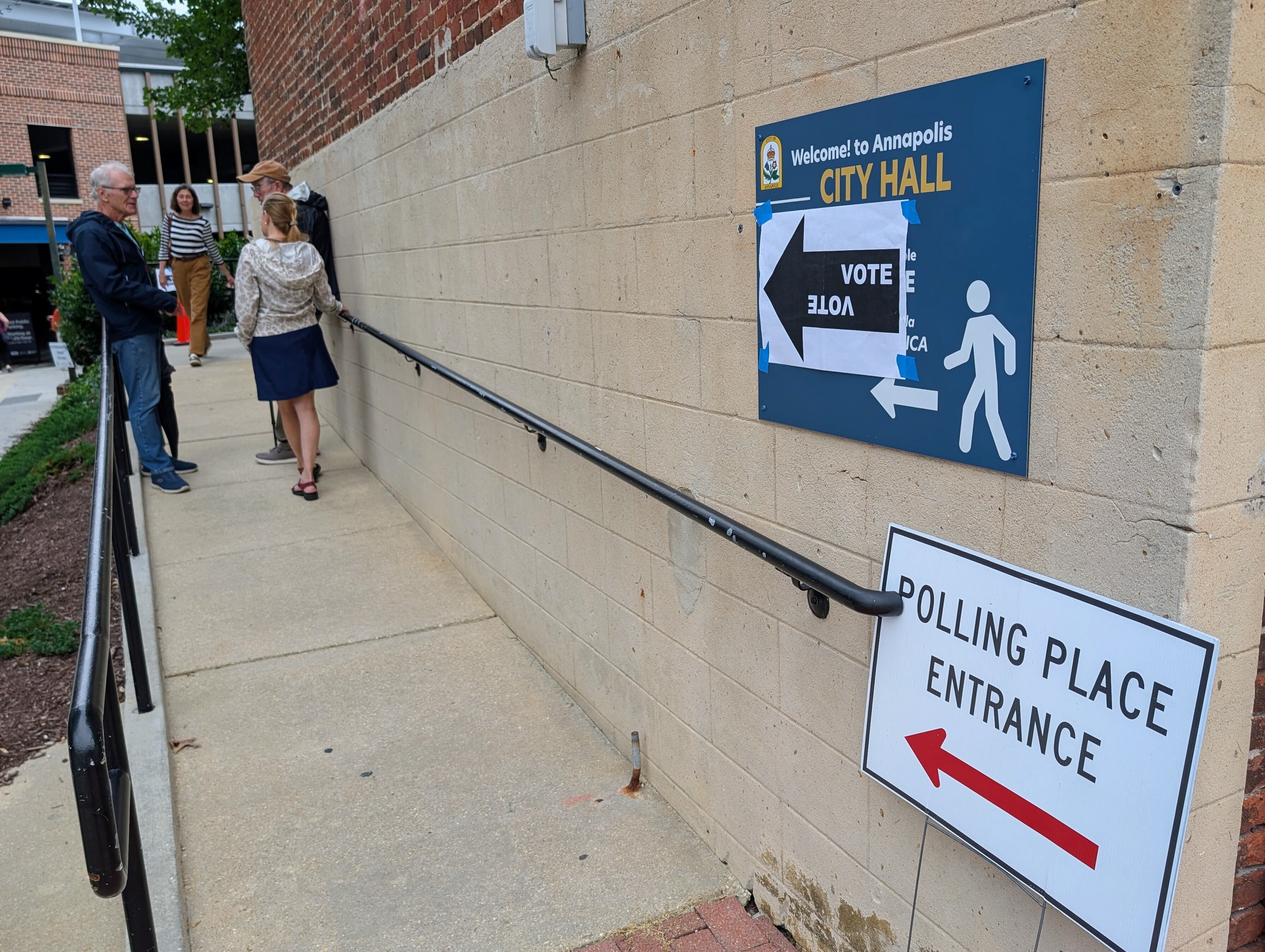 A few voters talk outside City Hall in Annapolis on Sept. 16, 2025, one of the polling places open for the primary election.