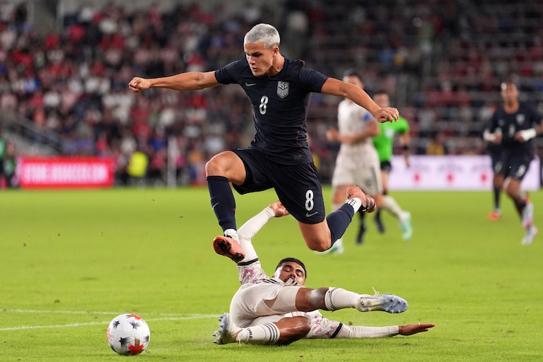 United States' Cavan Sullivan (8) leaps over Chile's Paulo Díaz while contolling the ball during the second half of an international friendly soccer match Tuesday, Sept. 29, 2026, in St. Louis. (AP Photo/Jeff Roberson)