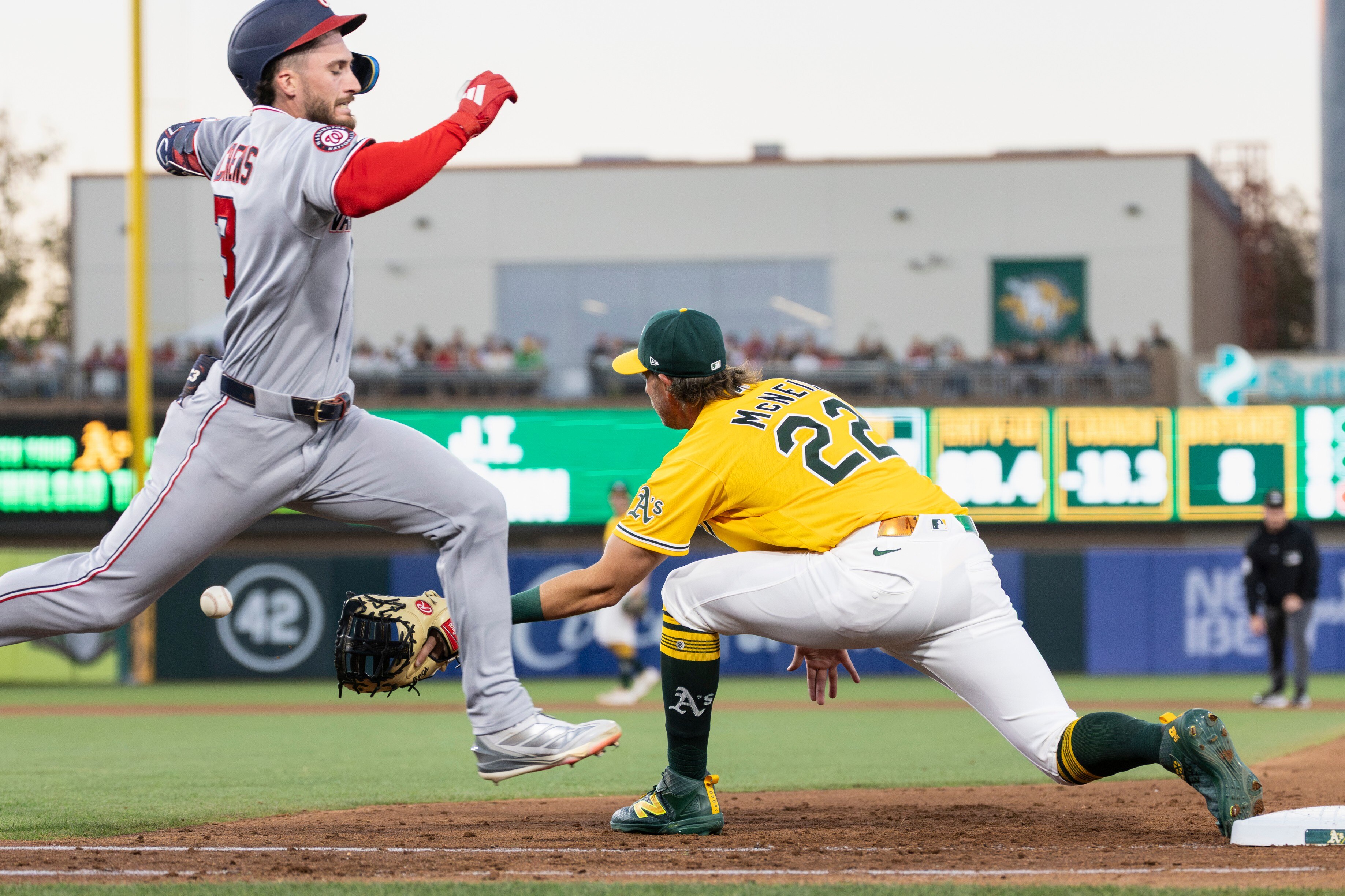 Athletics first baseman Jeff McNeil fields the throw as the Nationals’ Dylan Crews grounds out to lead off the fifth inning. Crews was called safe before the ruling was overturned.