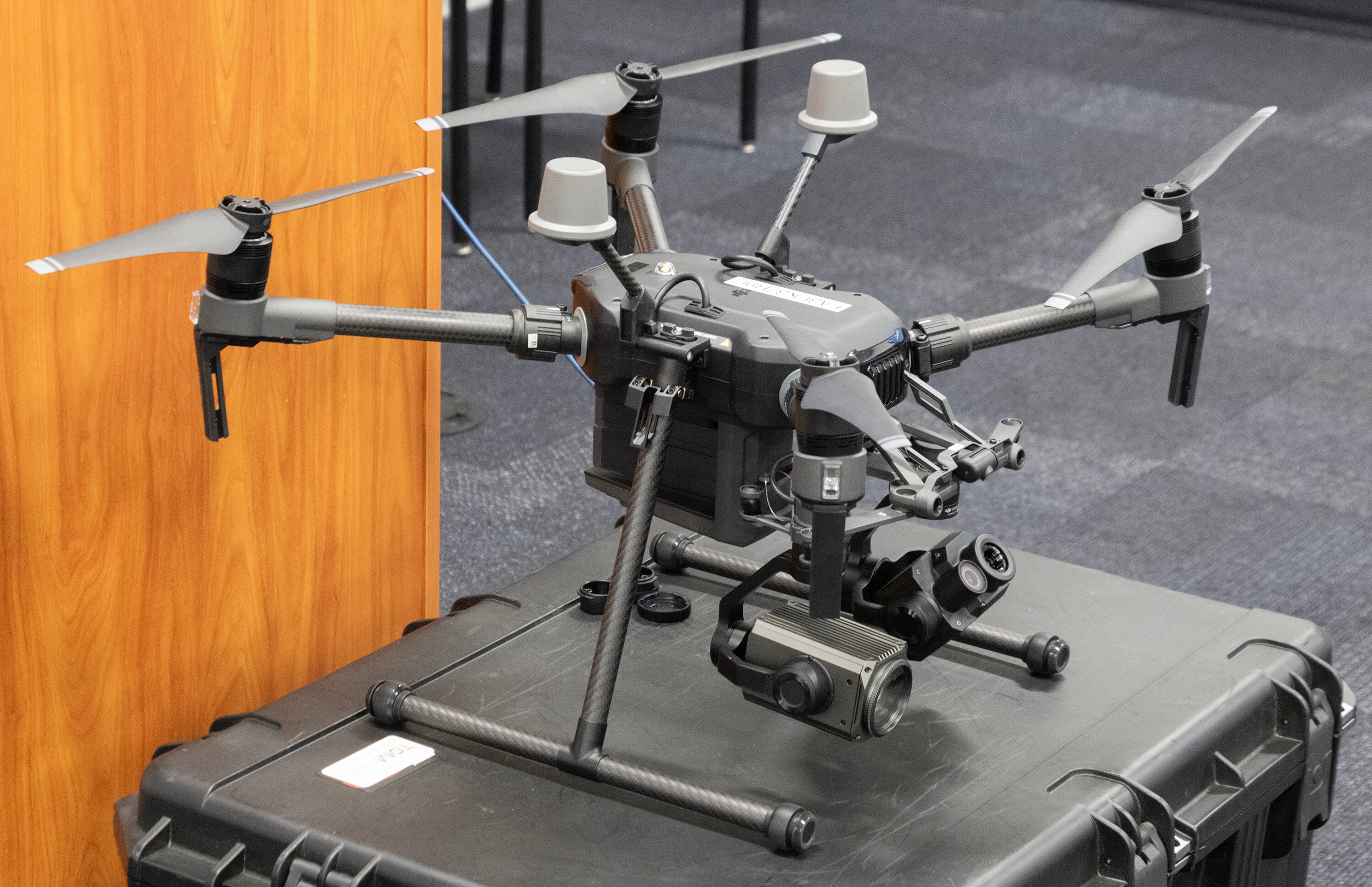 A Montgomery County Police Department drone — with four blades and cameras — rests on top of a heavy plastic case.