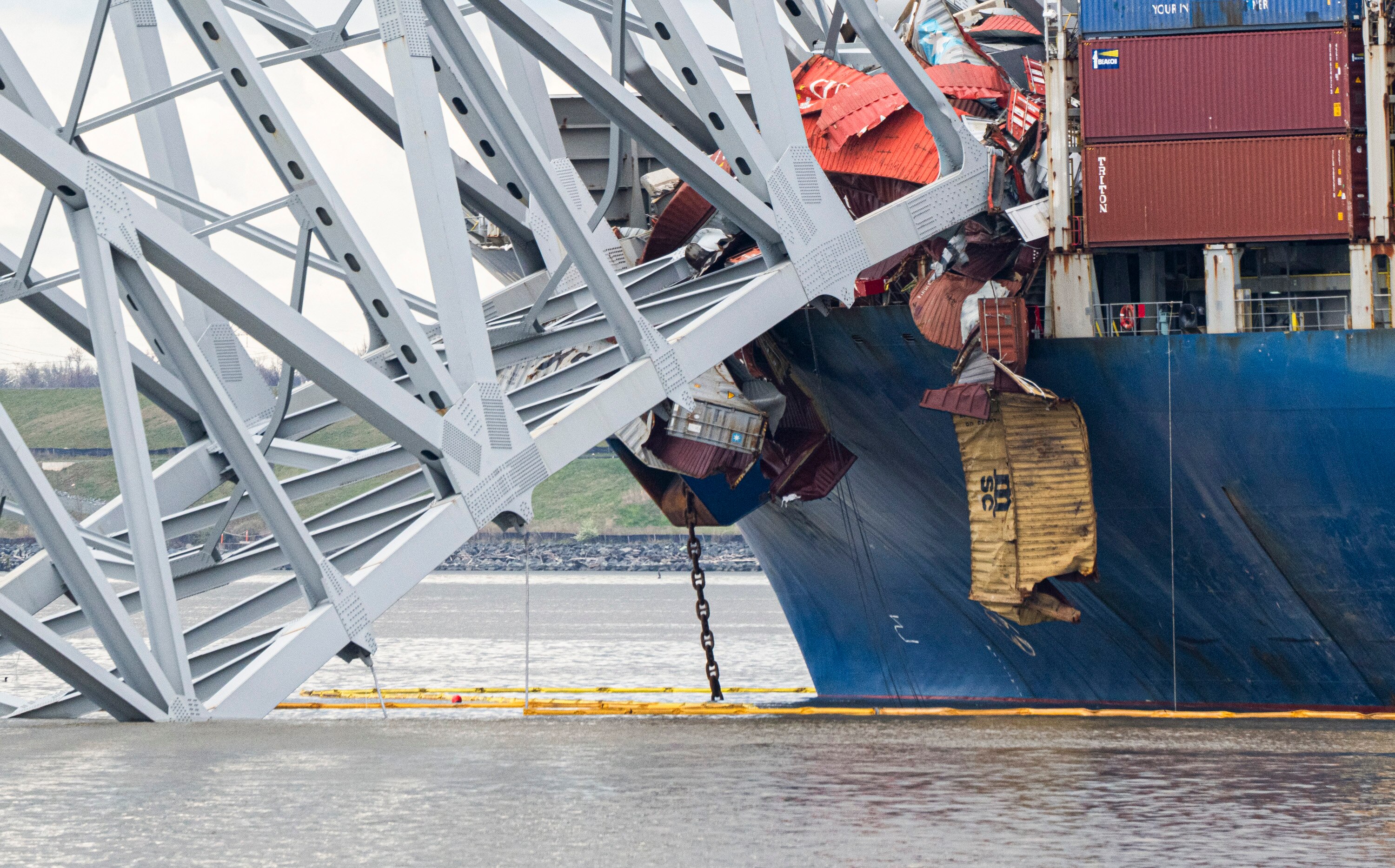 The site of the collapsed Key Bridge and the container ship that toppled it, The Dali, are seen from a debris retrieval vessel, The Reynolds, on April 4, 2024. 