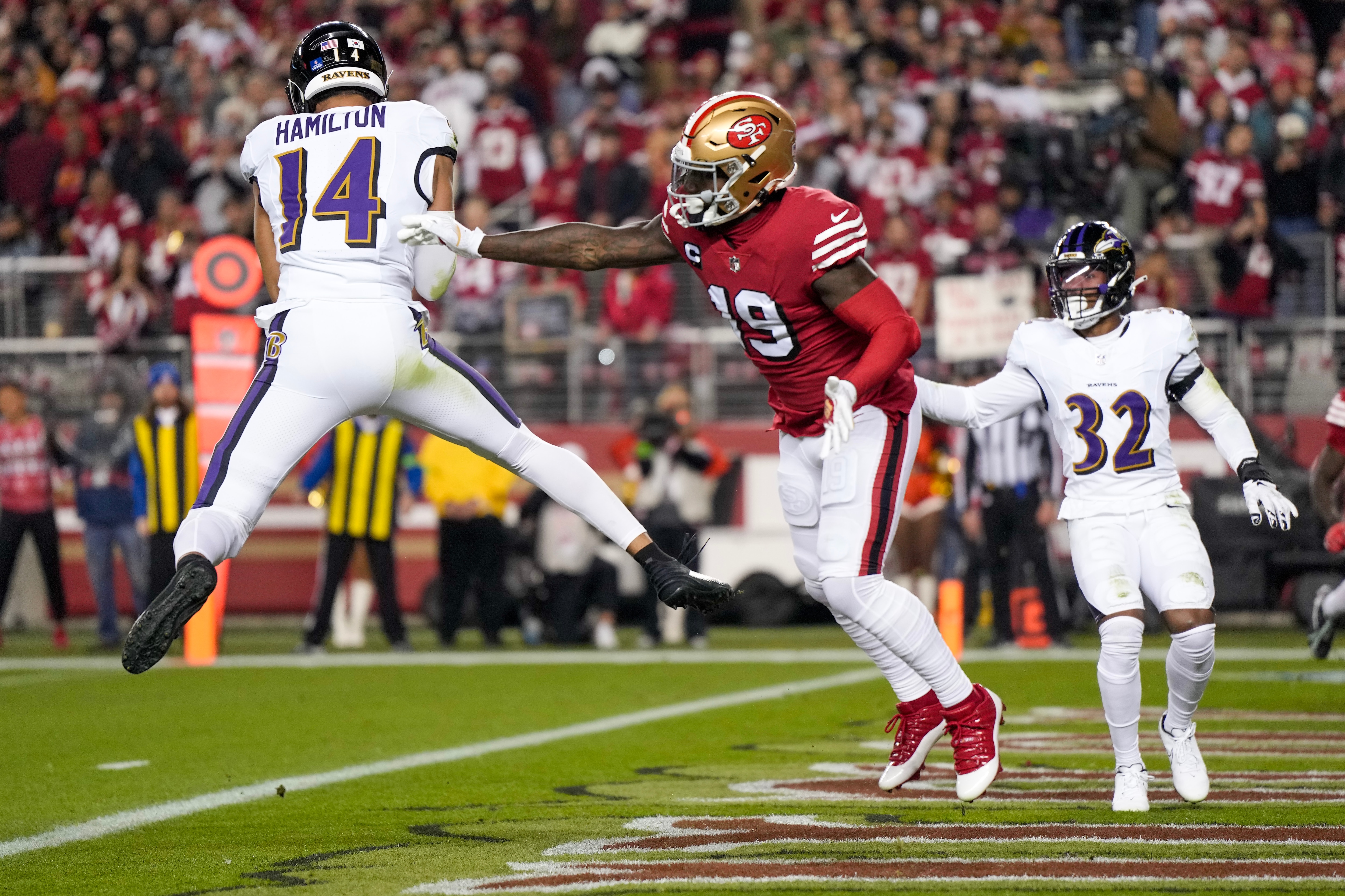 Kyle Hamilton, #14 of the Baltimore Ravens, intercepts a pass intended for Deebo Samuel, #19 of the San Francisco 49ers, during the first quarter at Levi's Stadium on Dec. 25, 2023 in Santa Clara, California.