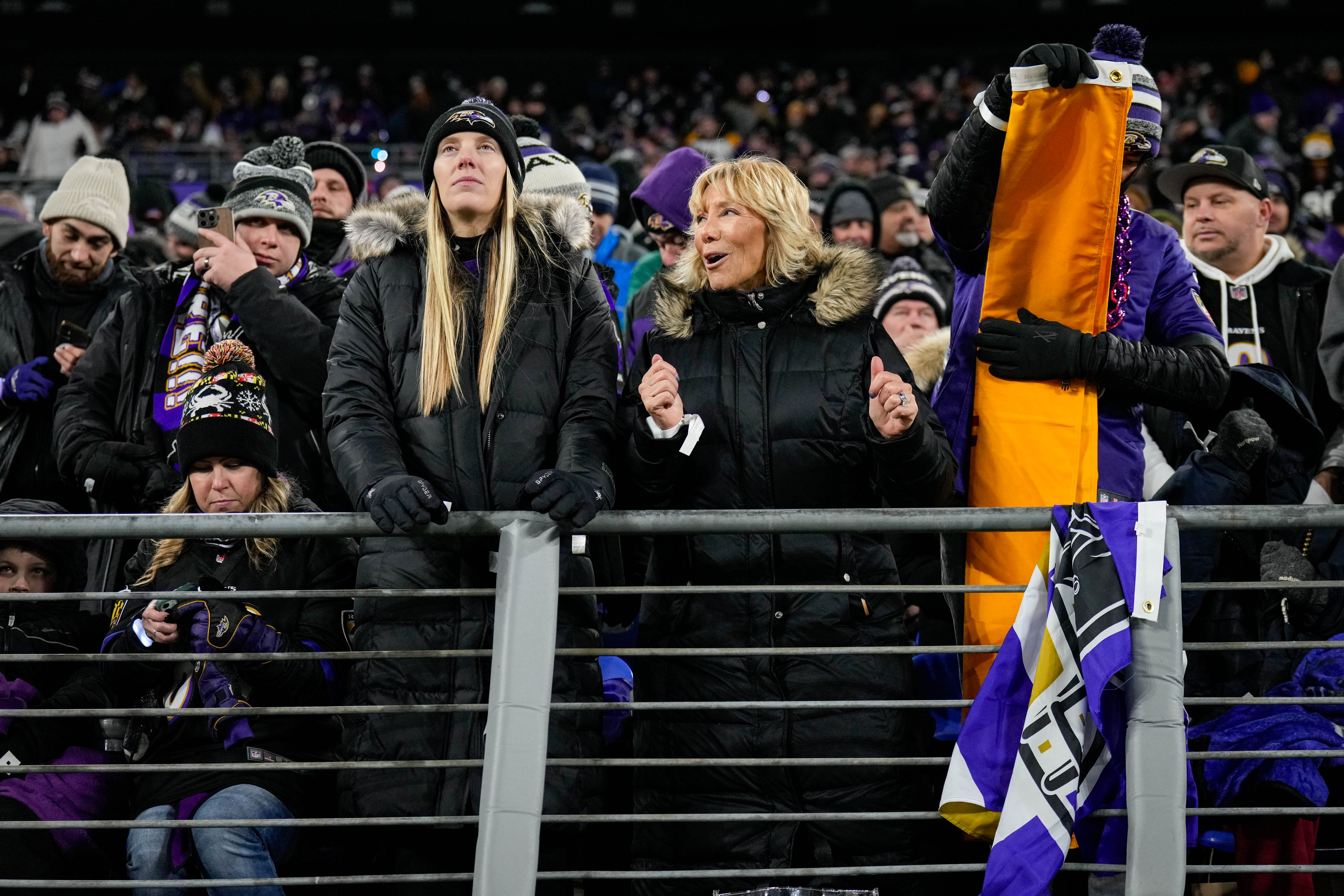 Karen Jones, middle, dances next to her daughter, Hayley Boyle Sparr, during Saturday’s game against the Pittsburgh Steelers from her seats in the west end zone at M&T Bank Stadium.