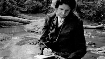 Rachel Carson, a longtime Silver Spring resident, is pictured sitting in the Northwest Branch of the Anacostia, near the future site of the Springsong Museum.