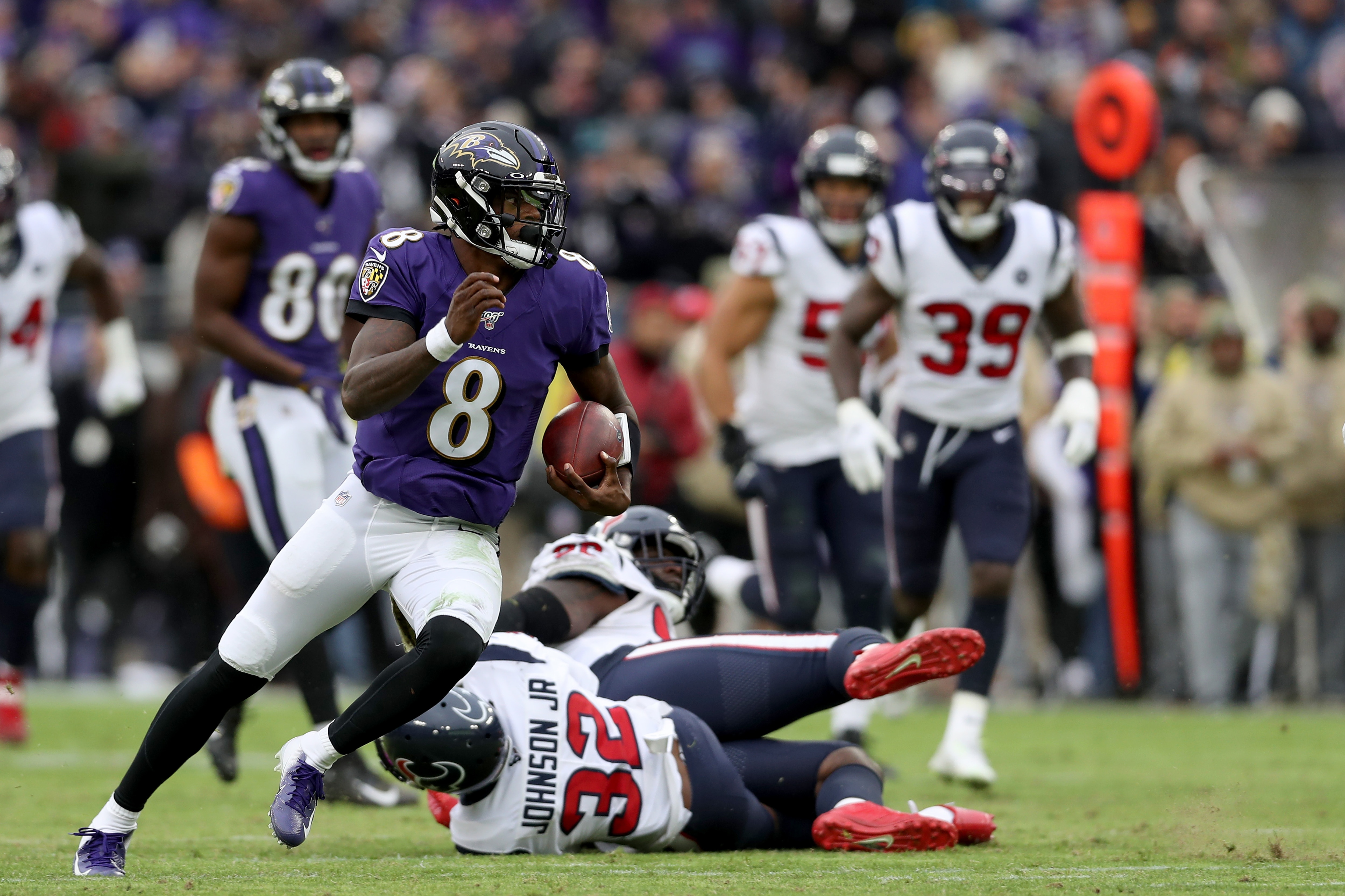 Lamar Jackson, #8 of the Baltimore Ravens, rushes for a first down in the third quarter against the Houston Texans at M&T Bank Stadium on Nov. 17, 2019 in Baltimore, Maryland.