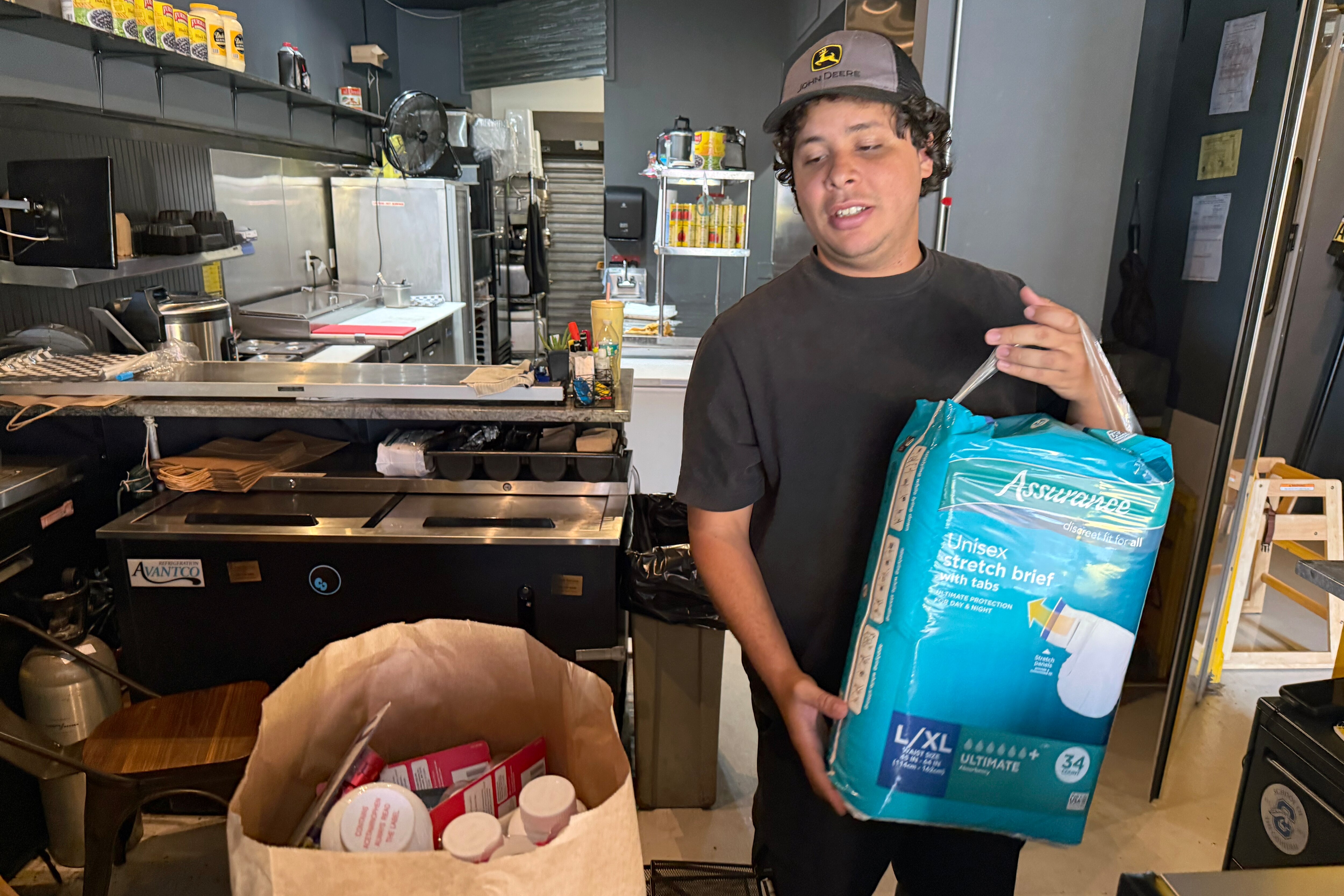FRIDAY, JUNE 26, 2026 - Luis Dams, one of the owners of Arepi, holding some of the goods already donated to those impacted by the earthquakes in Venezuela.