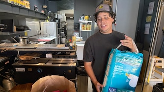 FRIDAY, JUNE 26, 2026 - Luis Dams, one of the owners of Arepi, holding some of the goods already donated to those impacted by the earthquakes in Venezuela.