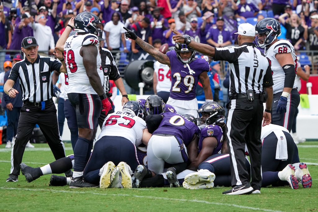 The Baltimore Ravens defense recovers Houston Texans quarterback C.J. Stroud’s fumble in the opening game of the season at M&T Bank Stadium on Sunday, September 10, 2023.