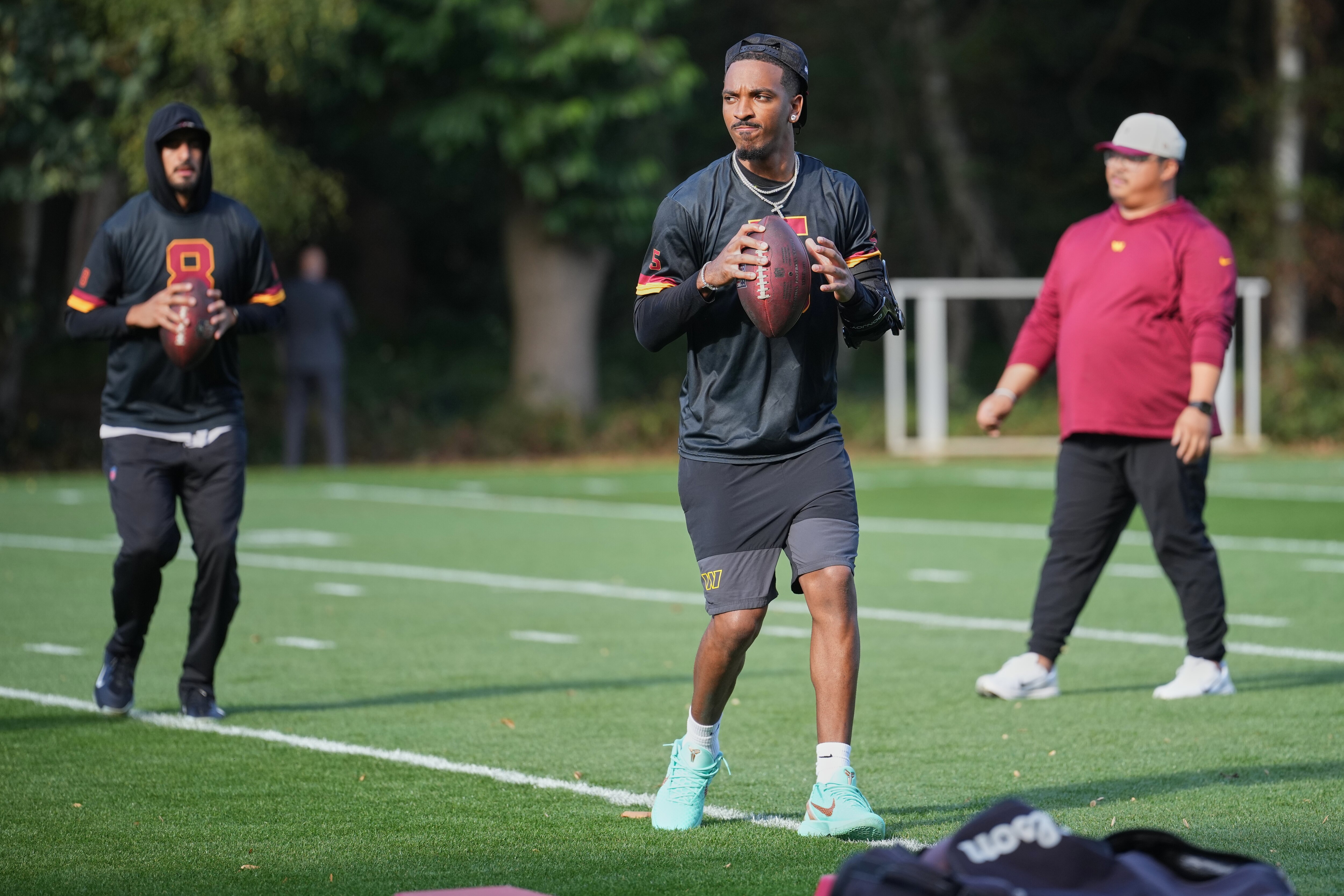 Washington Commanders quarterback Marcus Mariota, left, quarterback Jayden Daniels (5) work out during NFL football practice in London, Wednesday, Sept. 30, 2026, (AP Photo/Alastair Grant)